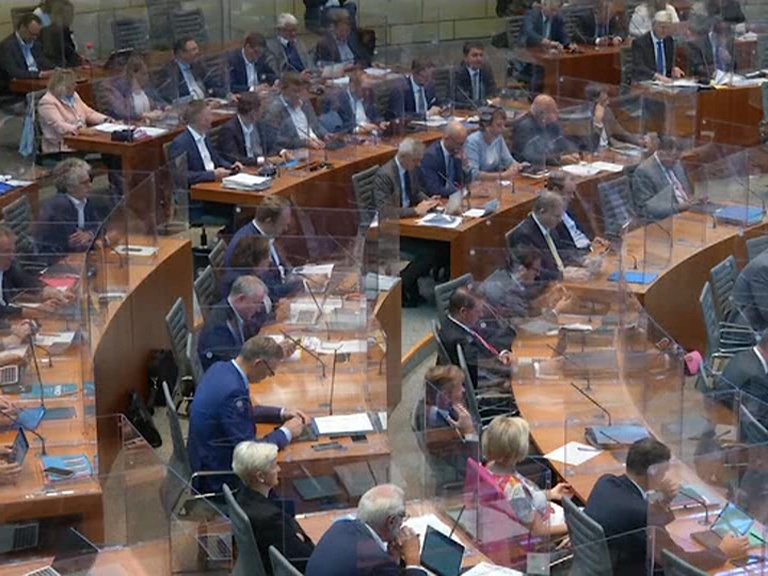 with the lawmakers separated by acrylic glass boxes in the Parliament session in Germany