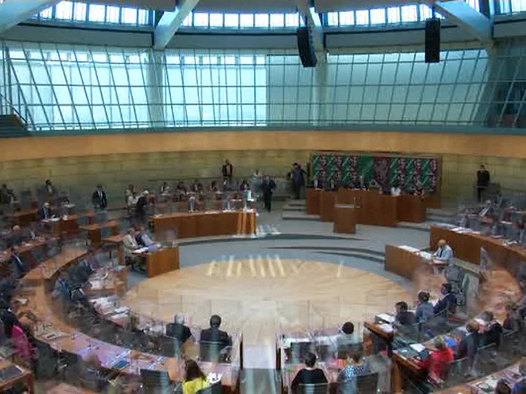 with the lawmakers separated by acrylic glass boxes in the Parliament session in Germany