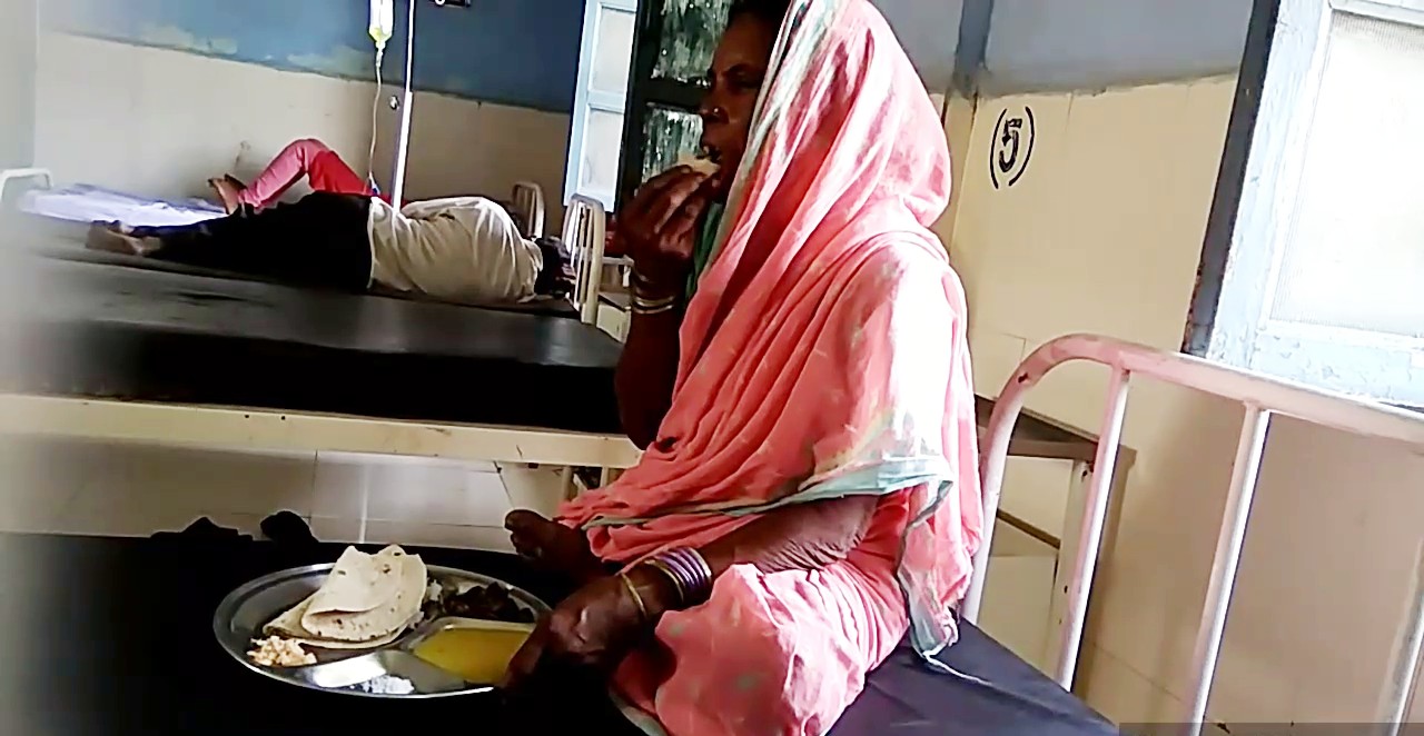 A woman eating food in the hospital