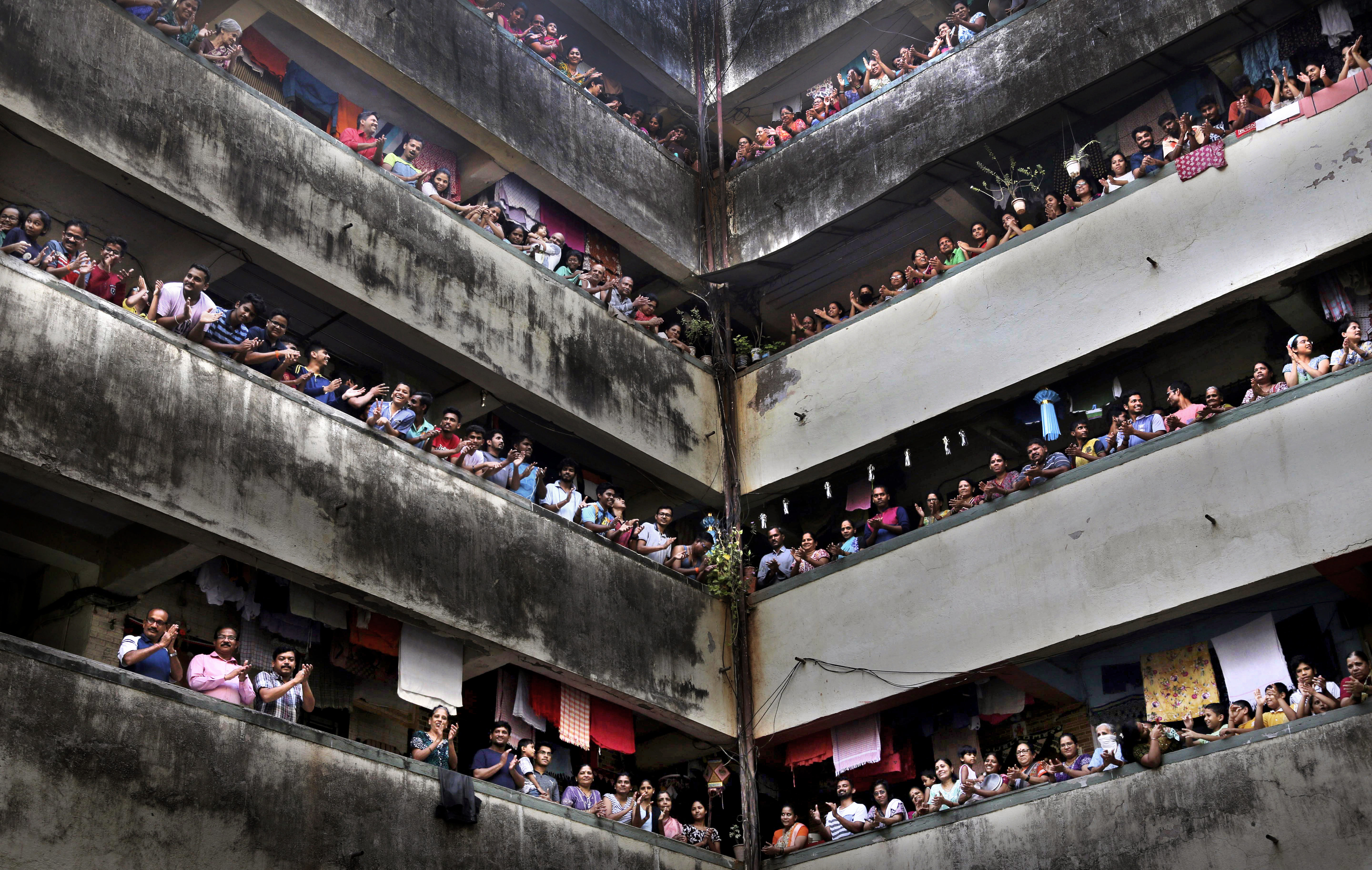 People clap from balconies in show of appreciation to health care workers at a Chawl in Mumbai. (File pic)