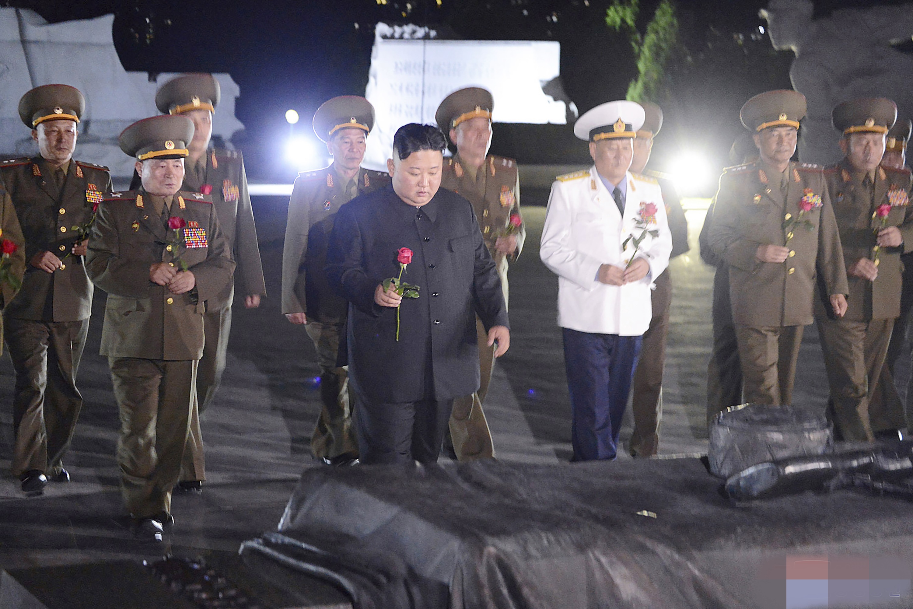 North Korean leader Kim Jong Un with military officers in uniforms prepares to lay a flower to the Fatherland Liberation War Martyrs' Cemetery in Pyongyang, North Korea.