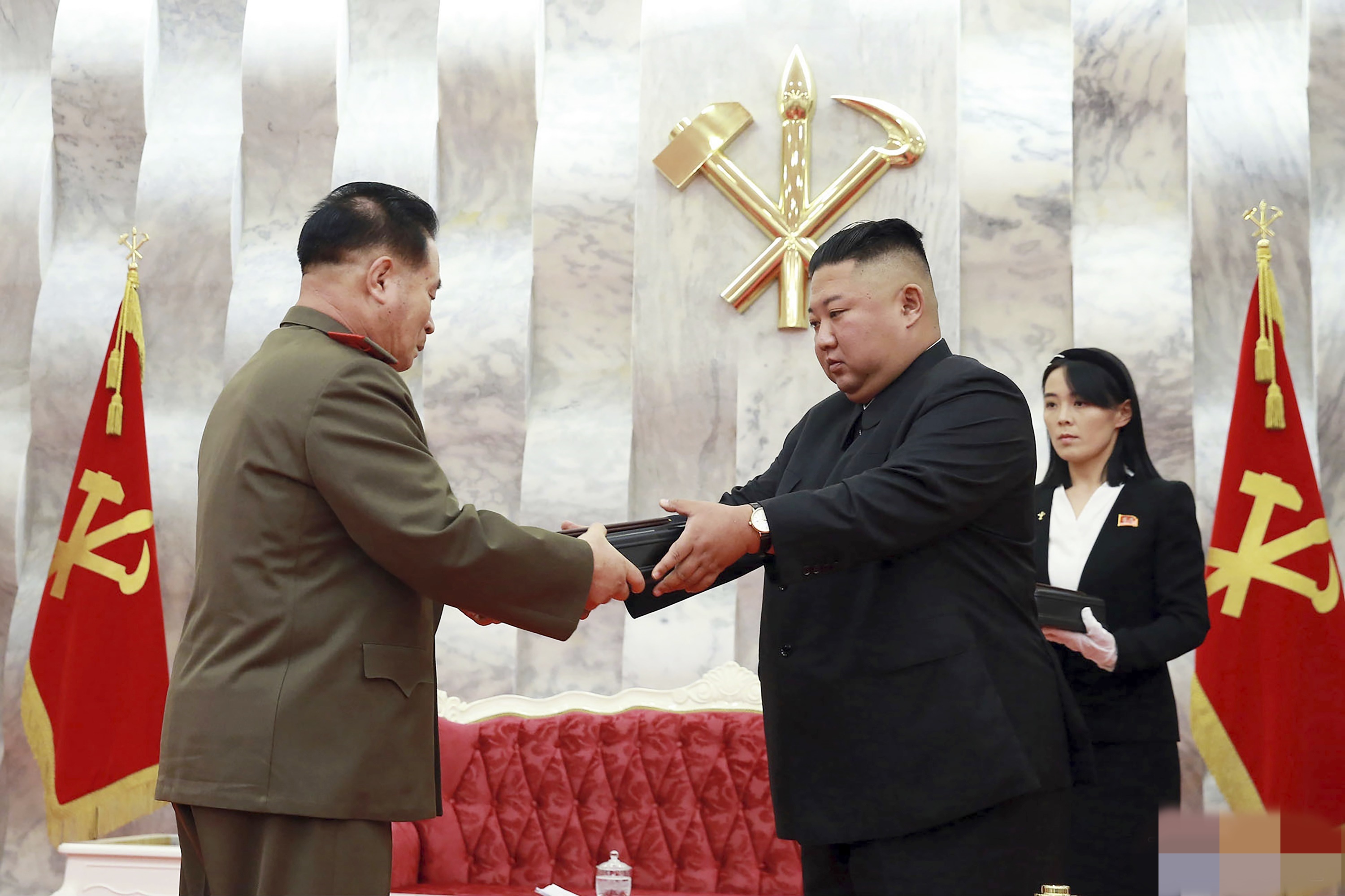 North Korean leader Kim Jong Un hands over a “Paektusan” commemorative pistol to a senior military official during a ceremony in Pyongyang, North Korea.