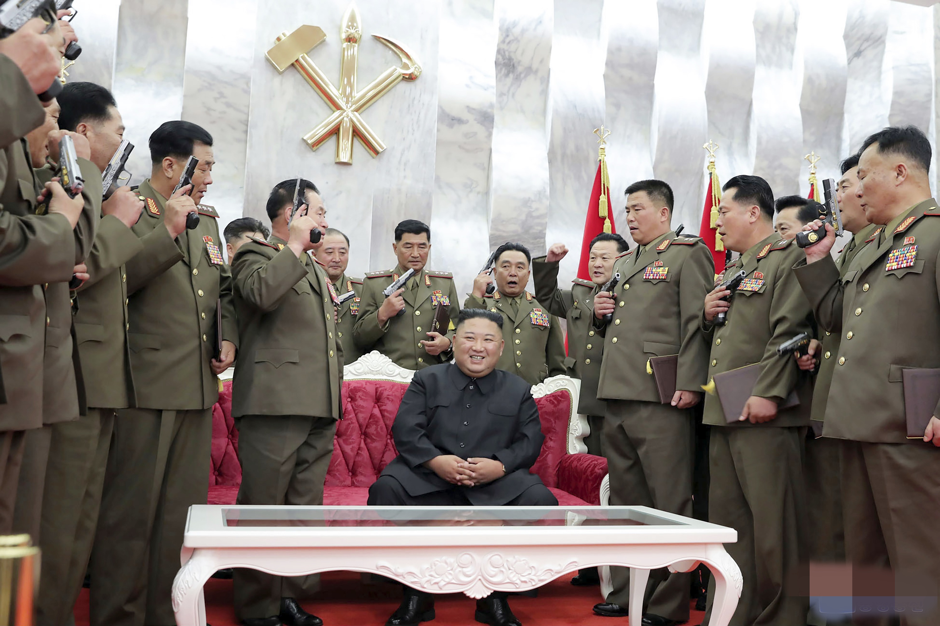 North Korean leader Kim Jong Un is surrounded by senior military officials holding “Paektusan” commemorative pistols they received from Kim during a ceremony in Pyongyang, North Korea.