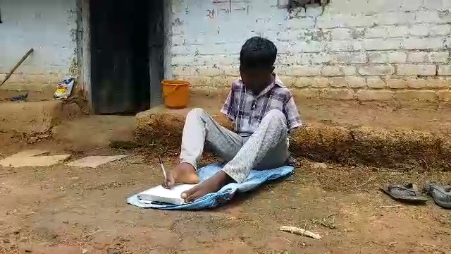 Krishna Kumar writing with his feet