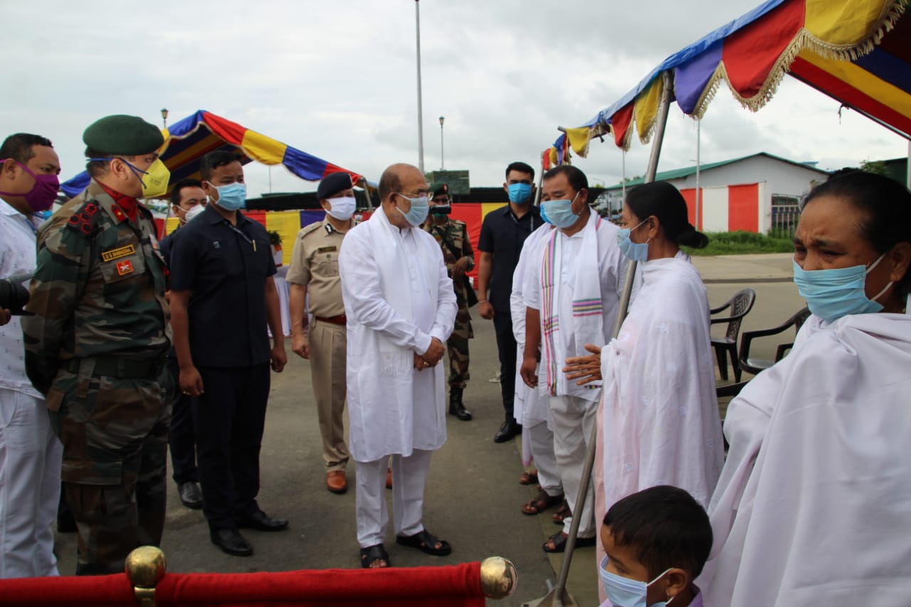 Chief Minister of Manipur N Biren Singh talking to the family members of the martyred soldiers