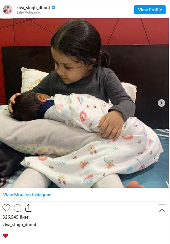 sakshi-shares-a-picture-where-ziva-cradling-infant-fans-ask-msds-new-baby