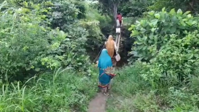 People cross the bridge after risking their lives