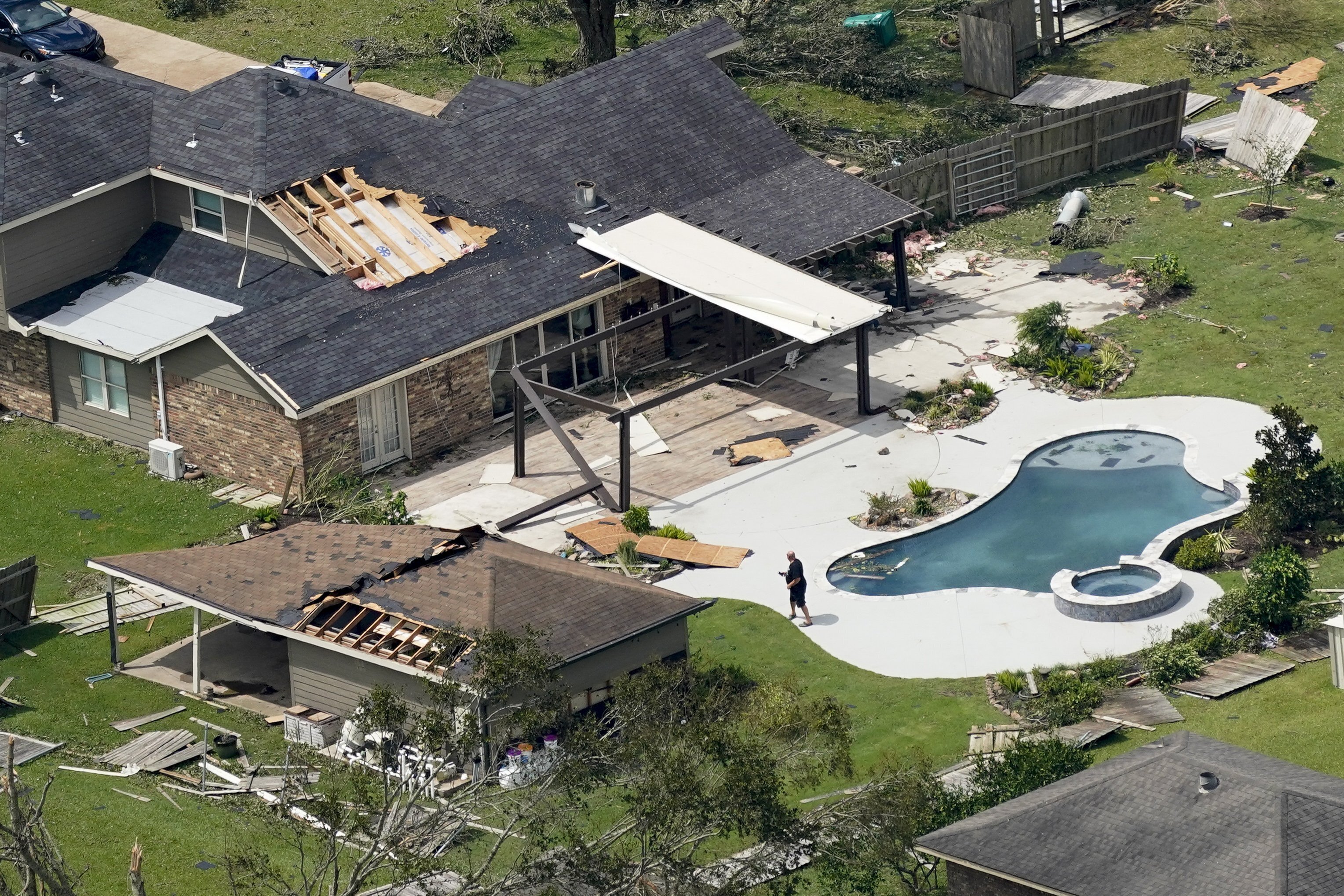 A person surveys the damage on Thursday after Hurricane Laura went through the area near Lake Charles.