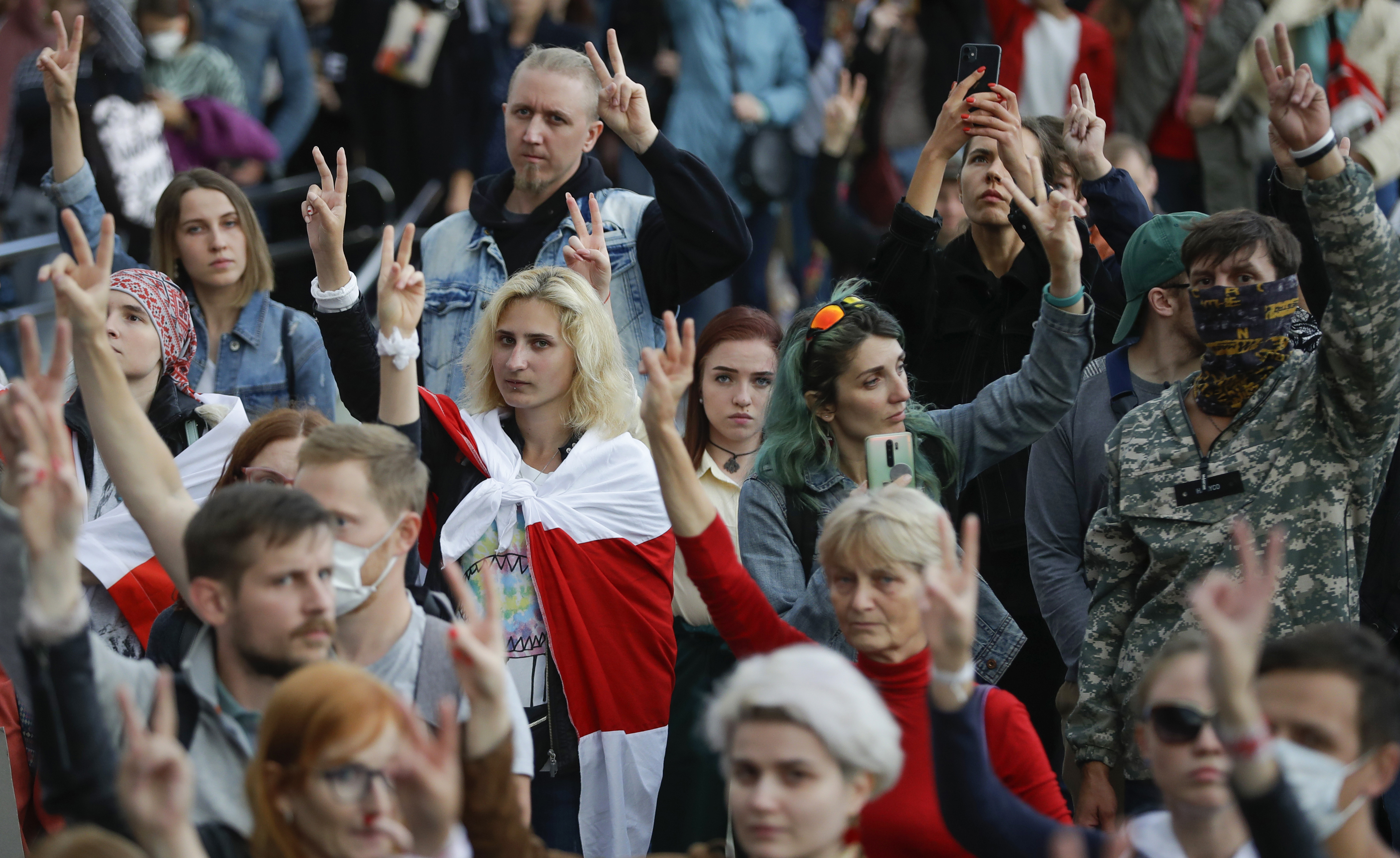 People gesture during a protest at the Independence Square in Minsk, Belarus, Thursday.