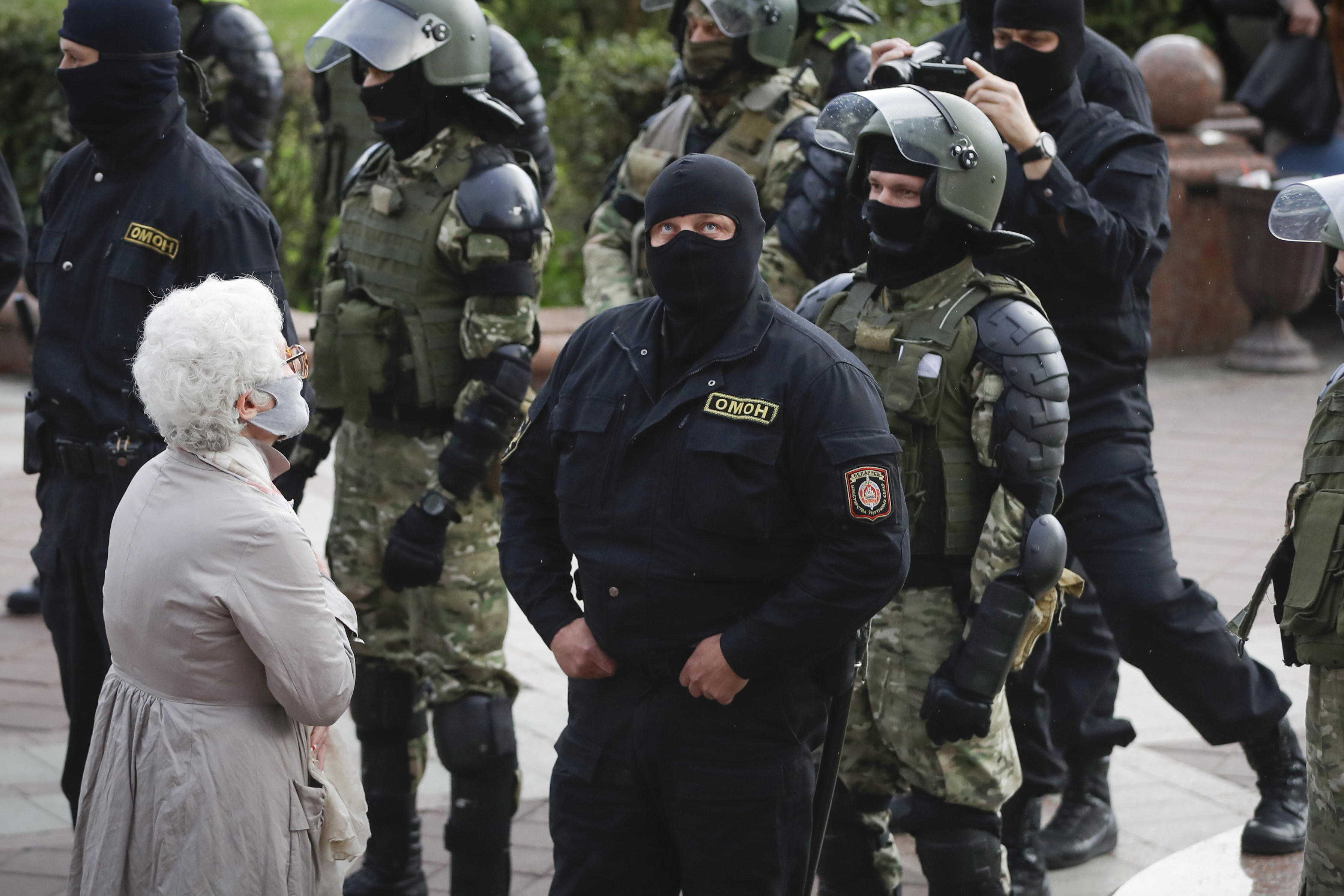 A woman reacts in front of a riot police blockade during a protest at the Independence Square in Minsk, Belarus, Thursday.