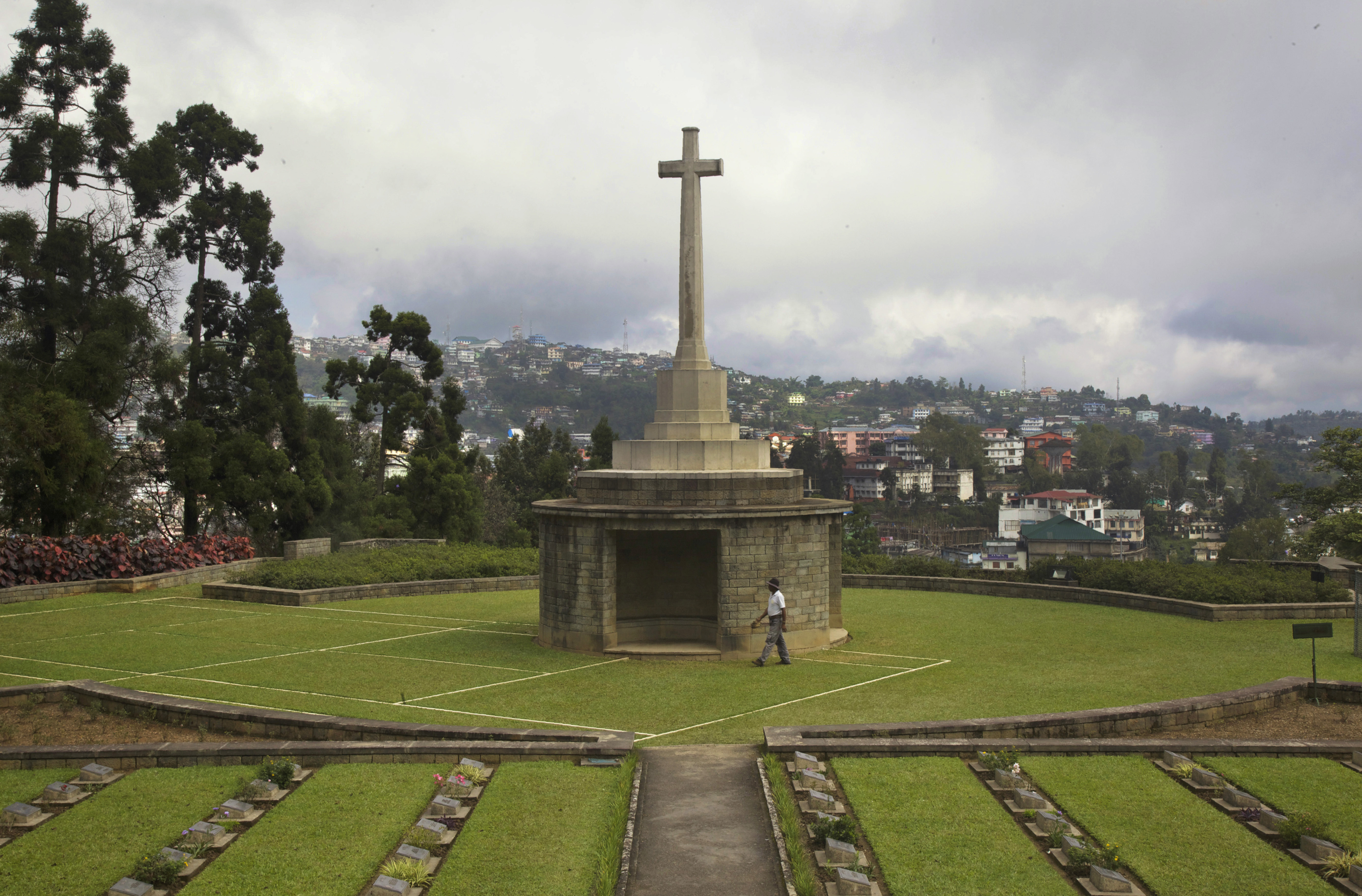 A gardener walks past the preserved outlines of a tennis court around where some of the fiercest battles were fought in Kohima, now part of the Kohima War Cemetery, the final resting place of more than 1,420 Commonwealth servicemen of World War II, in Kohima. (File)