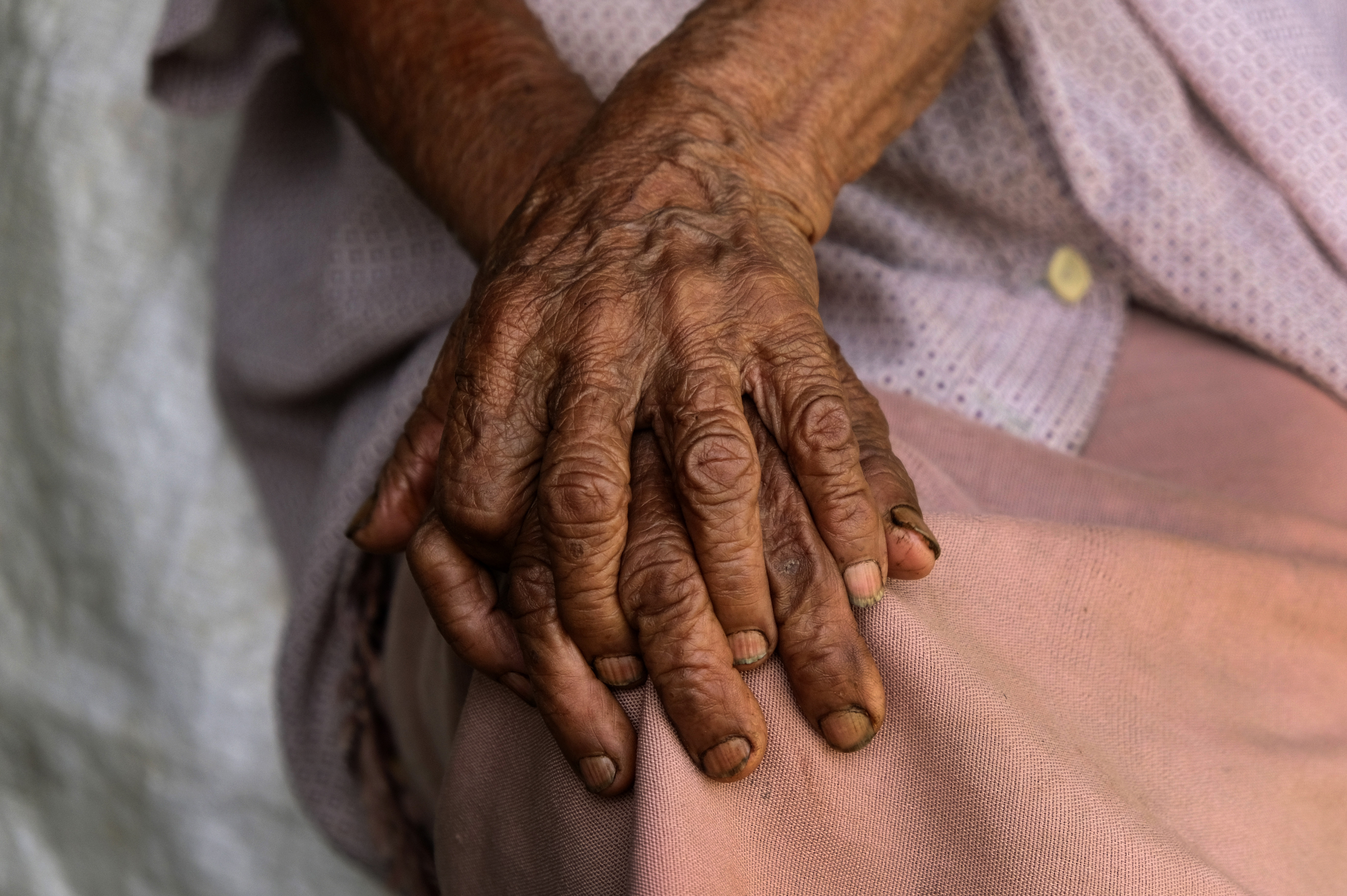 Kuozeu Vizo, a 98-year-old Angami Naga woman, clasps her hands together as she speaks about memories of the bloody battle between the Japanese and British Commonwealth forces that took place in her village during the World War II, in Kohima. (File)