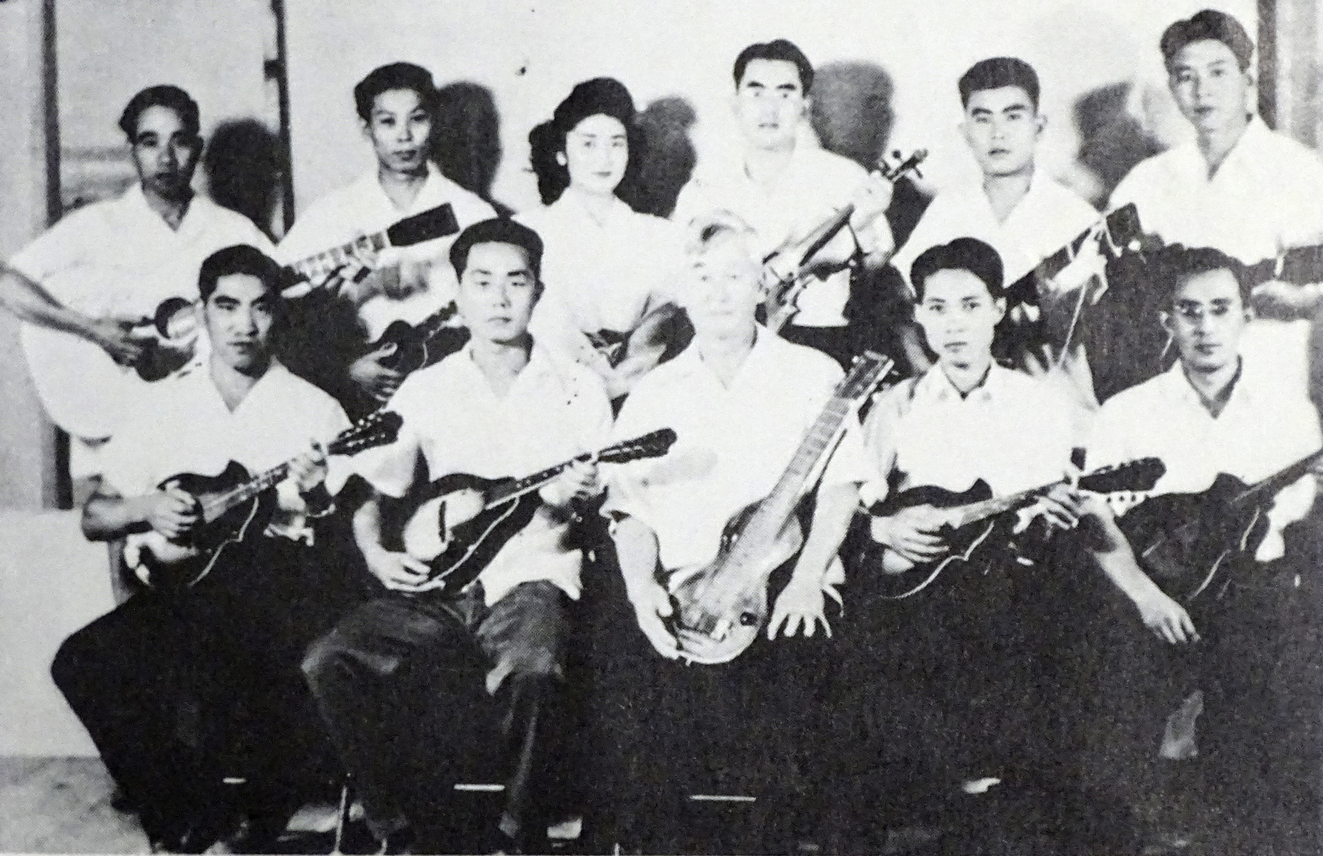 In this 1943 photo provided by Hidekazu Tamura, Tamura, second from left in front row, poses with his Mandolin band at Gila River War Relocation Center at southeast of Phoenix during the pacific war period. (File)