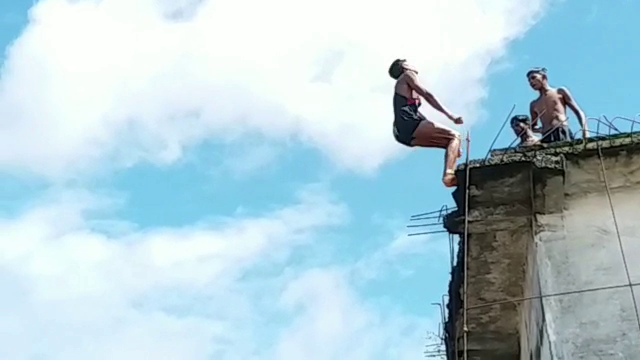 People leaping in flooded Narmada