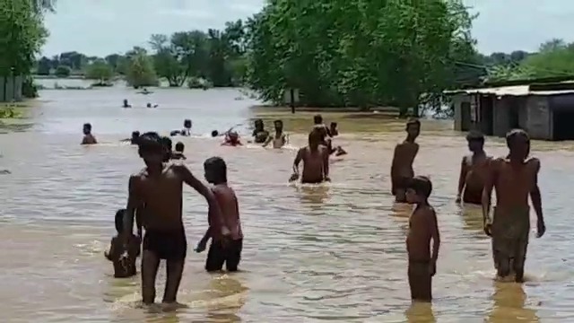 People leaping in flooded Narmada