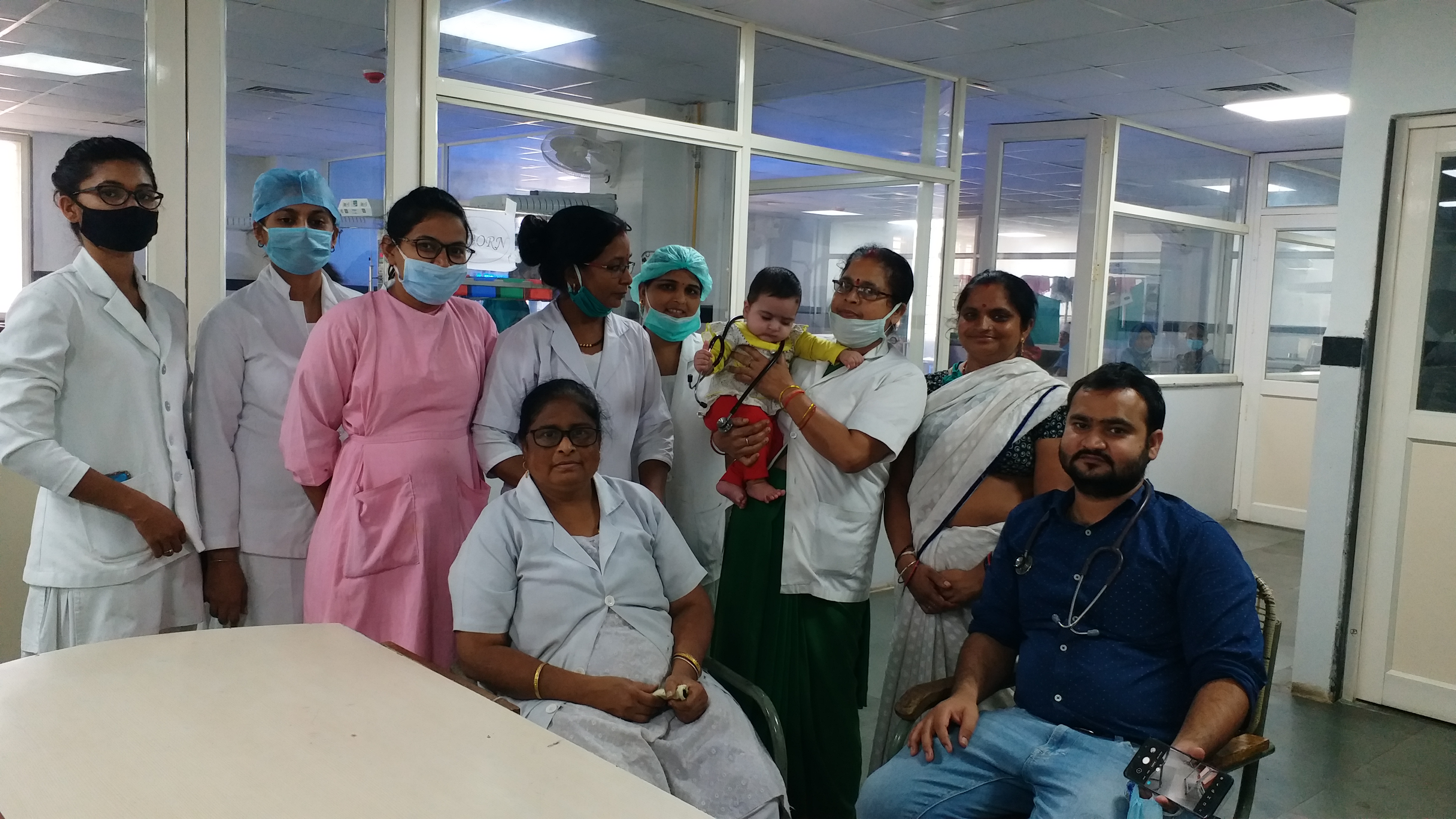 nurses nourishing eight month baby as mother