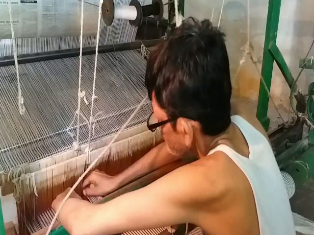 Workers making cloth using khadi yarn