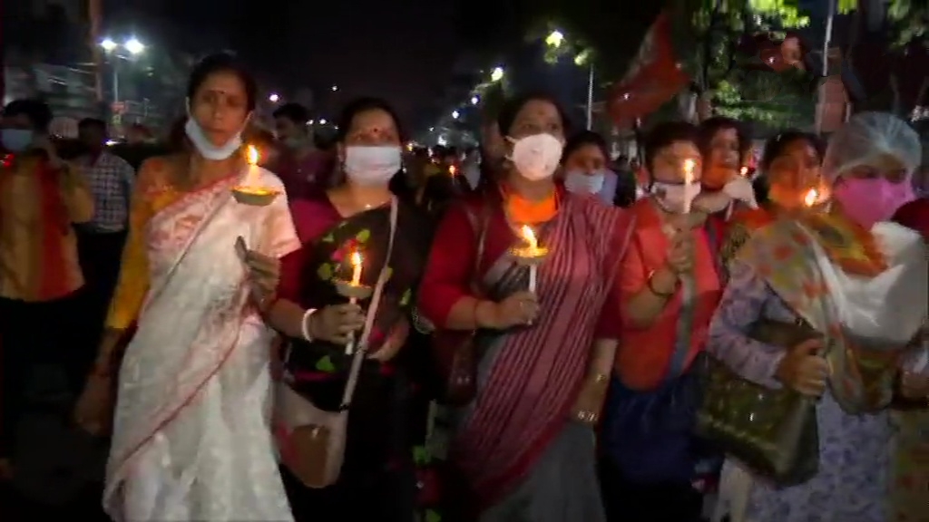 BJP workers hold a candlelight vigil in Kolkata against the state government