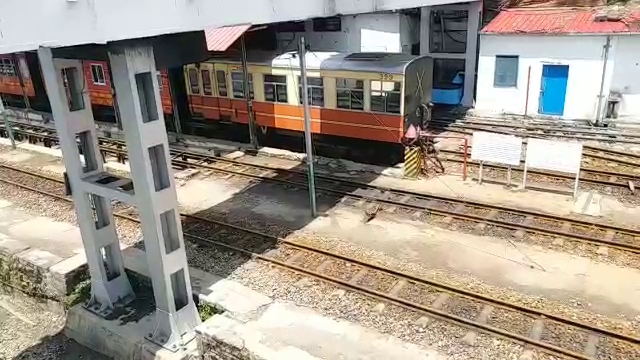 A coach stands dormant on the tracks