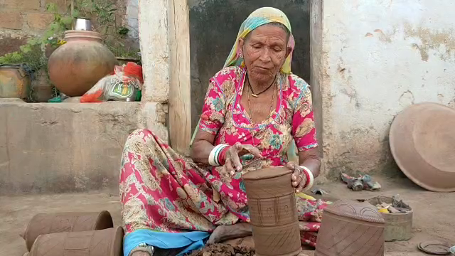 Old lady making pottery