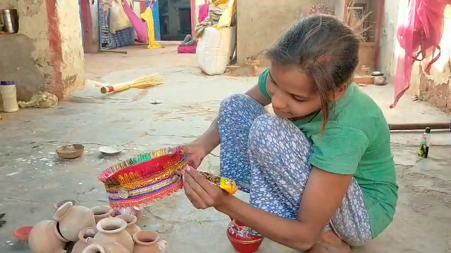 Girl making decorative items from clay