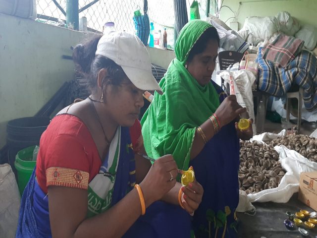 Women making diya of cow dung