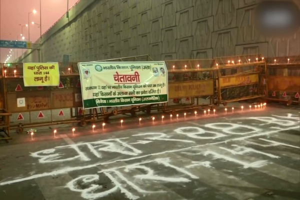 Protesting farmers light candles at the Ghazipur border to mark Guru Nanak Jayanti