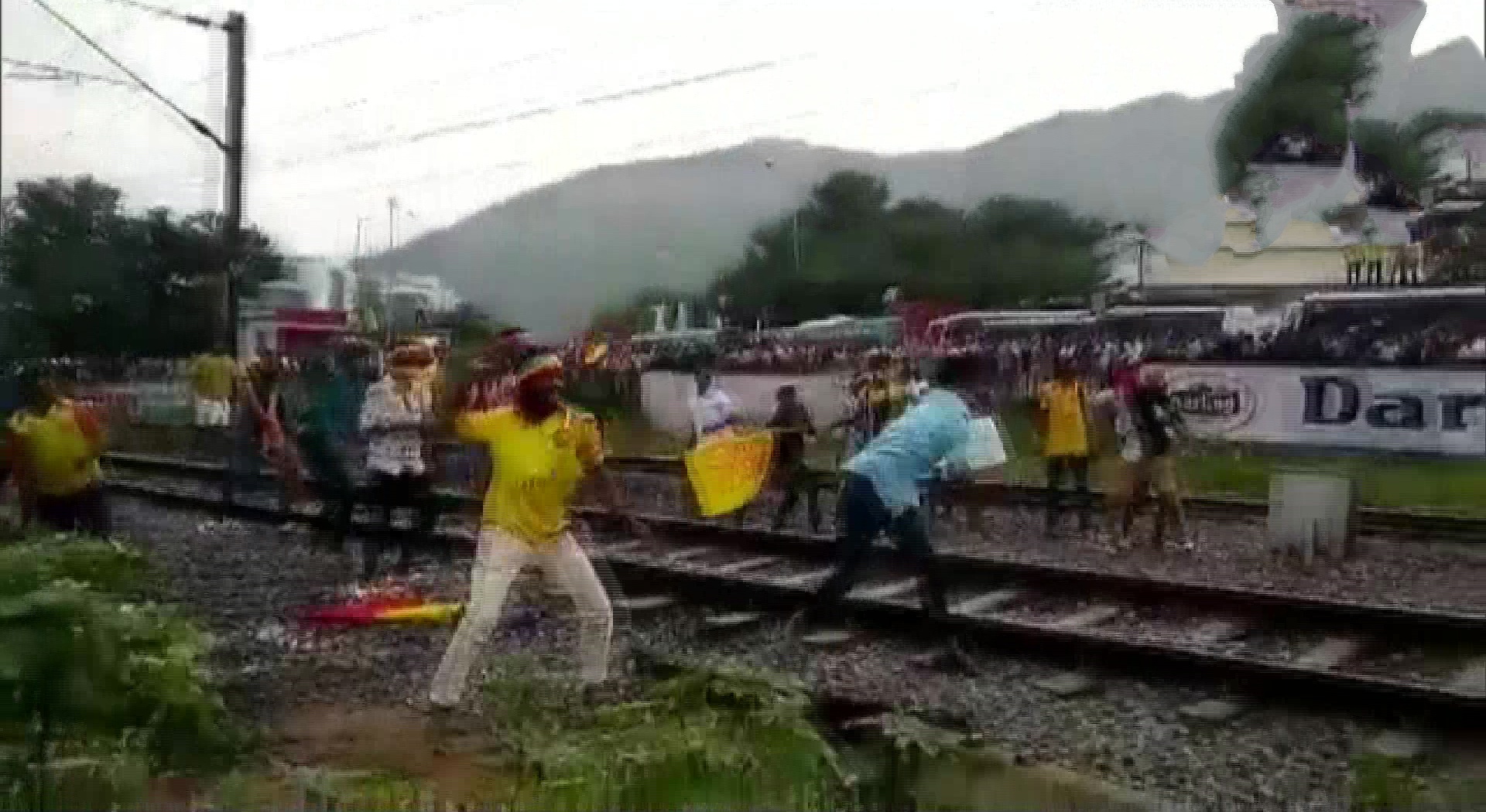 Paattali Makkal Katchi workers pelt stones at a train and block road in Perungalathur after being stopped by police