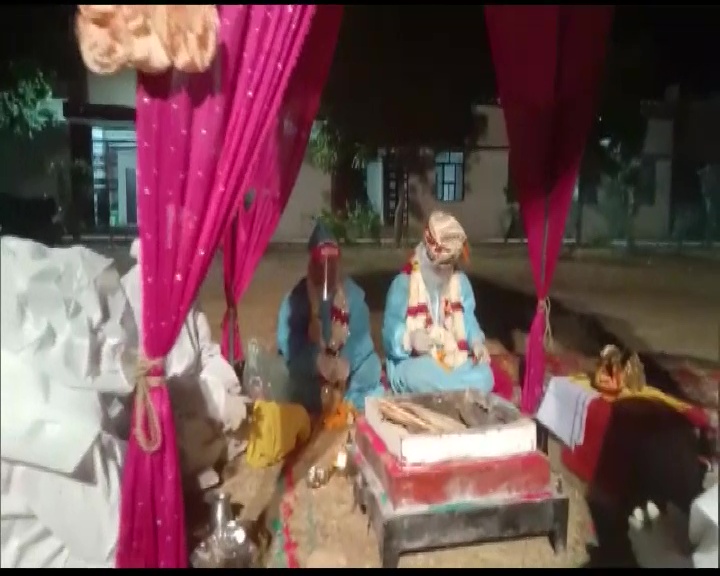 A couple gets married at Kelwara Covid Centre in Bara, Shahbad wearing PPE kits