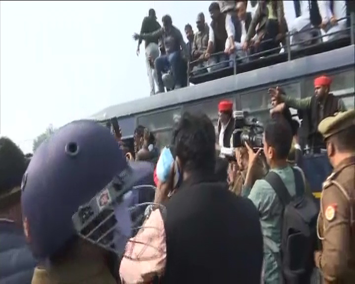 Samajwadi Party (SP) chief Akhilesh Yadav and party workers stage a sit-in protest after their vehicles were stopped by Police