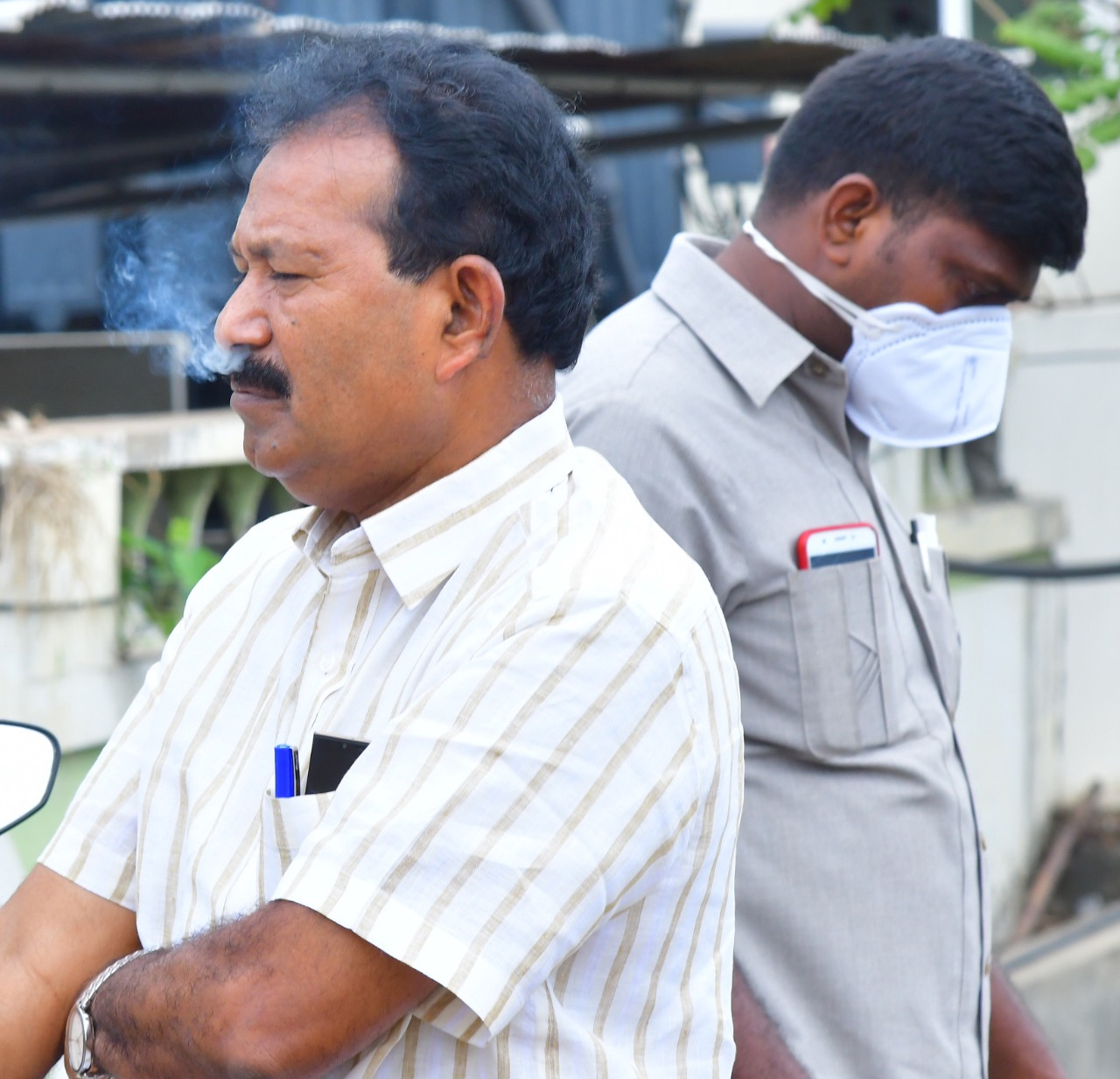 mla-musthafa-smoking-at-fire-accident-at-guntur