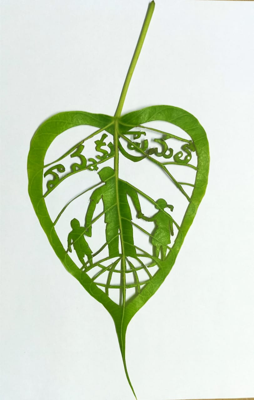 teacher make an art on leaf on the special eve of international father's day