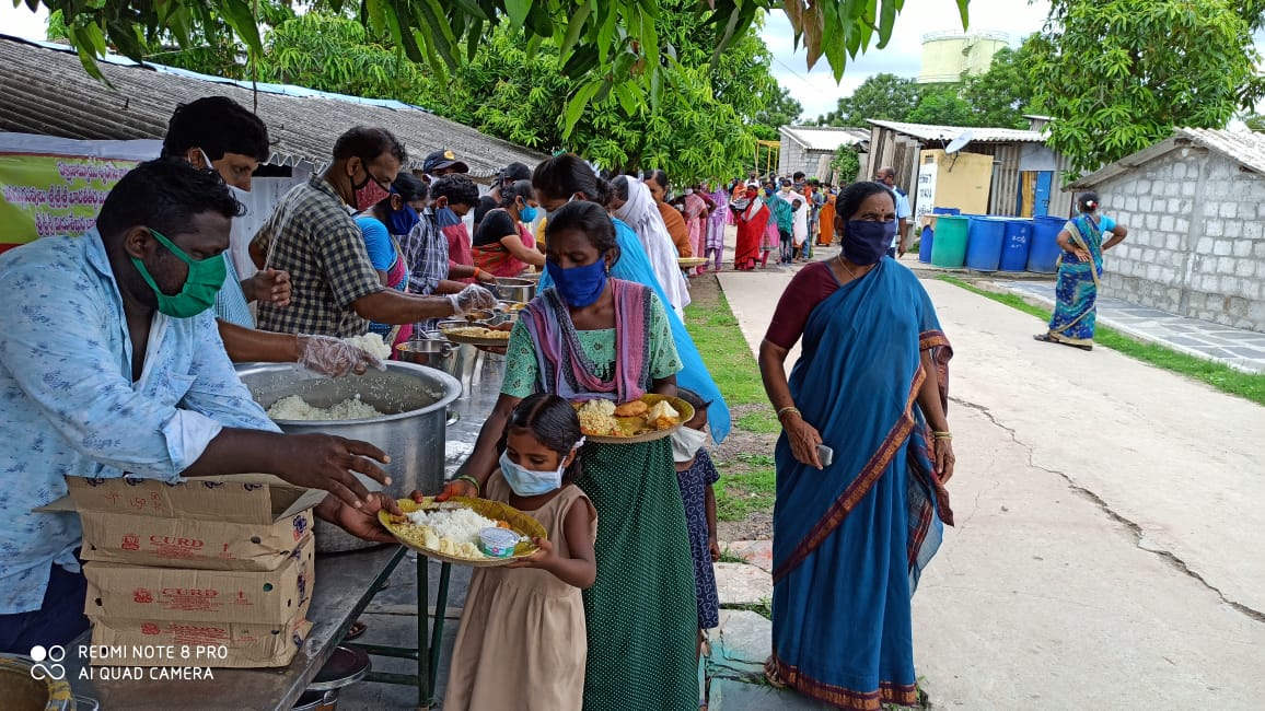 lady distributing food to poor