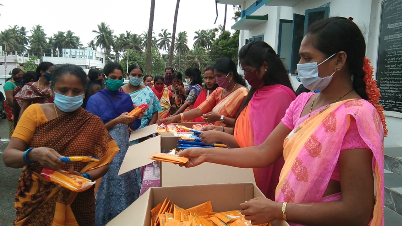 teacher distributing sanitary pads, napkins to poor ladies in ravulapalem constituency