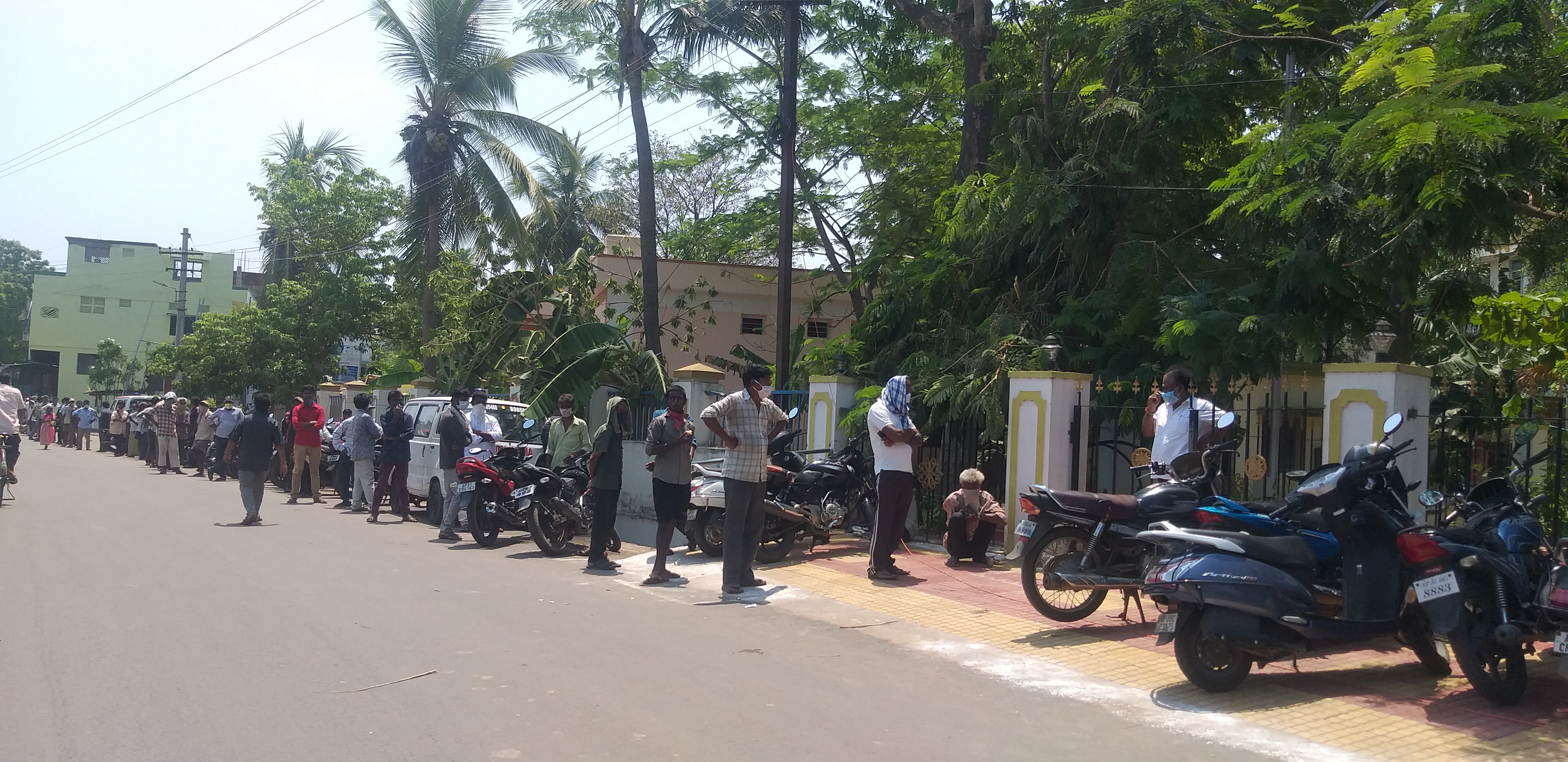 homeless people waiting for lunch at anna canteen in anakapalle