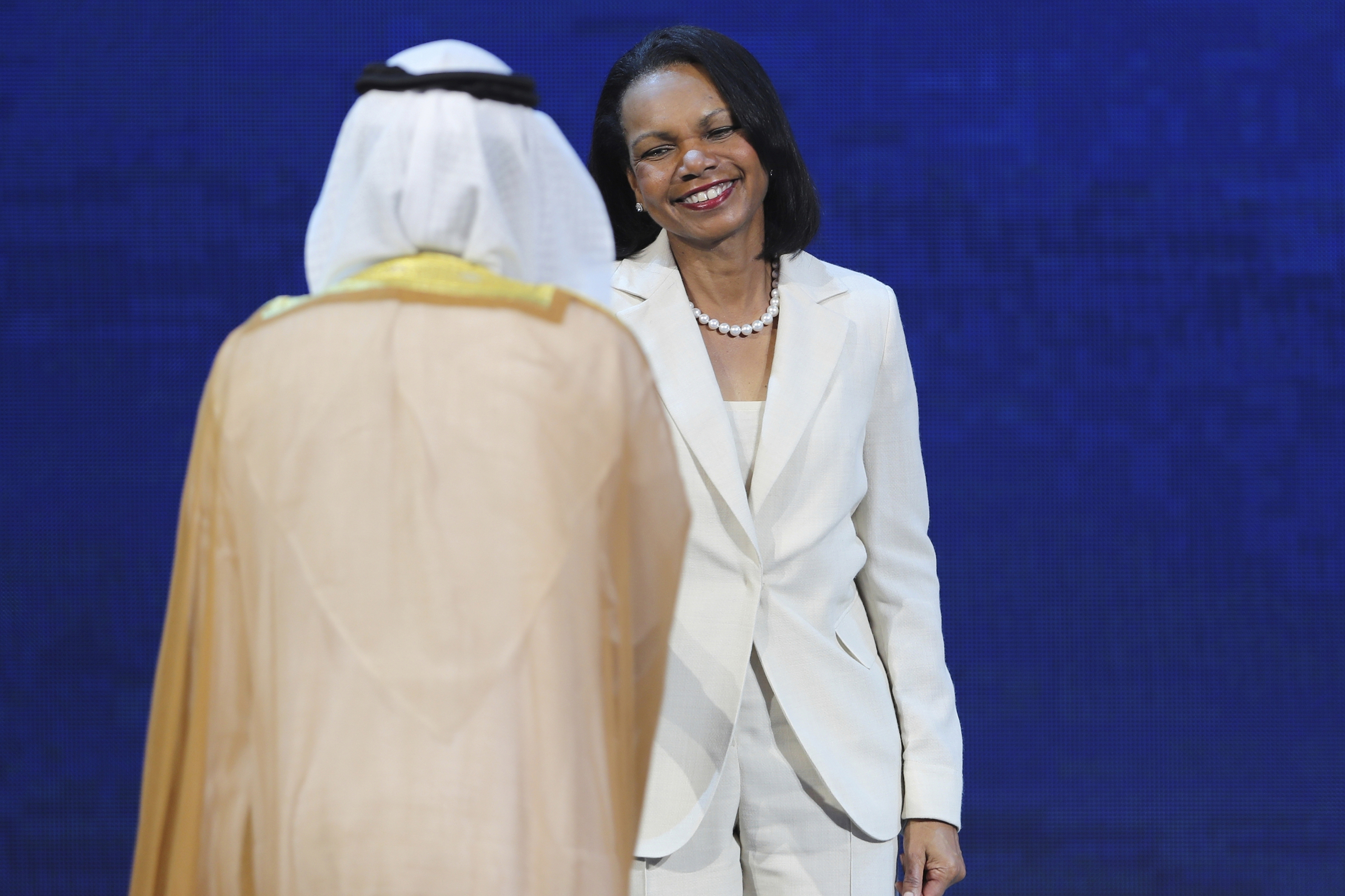 In this Nov. 11, 2019 file photo, former U.S. Secretary of State Condoleezza Rice shakes hands with UAE Energy Minister Suhail al-Mazrouei at the opening ceremony of the Abu Dhabi International Petroleum Exhibition & Conference (ADIPEC) in Abu Dhabi, United Arab Emirates.