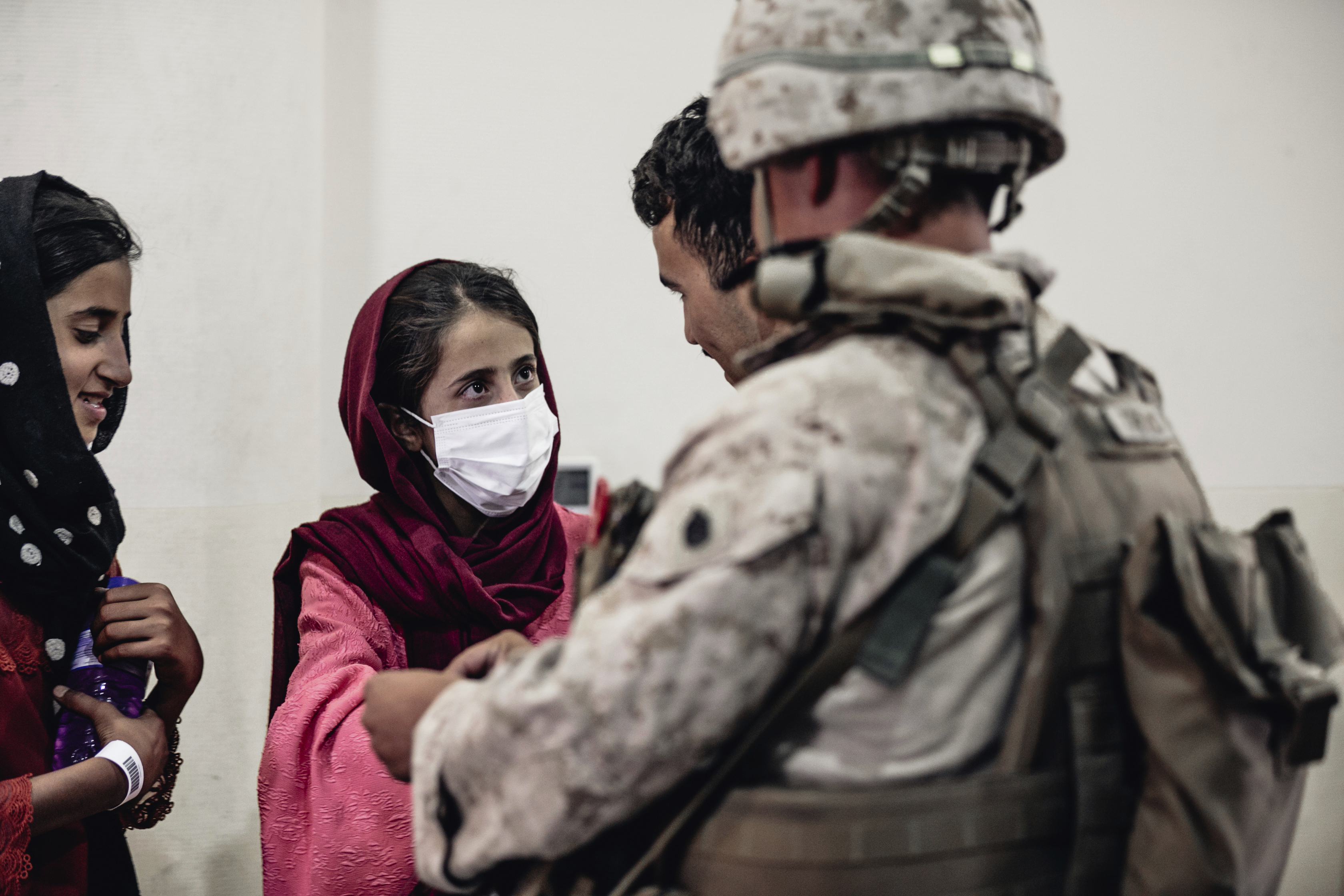 A Marine processes youth to be evacuated, at Hamid Karzai International Airport