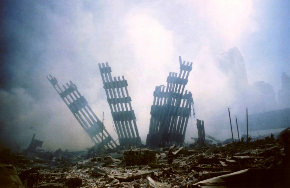 In this Tuesday, Sept. 11, 2001 file photo, the remains of the World Trade Center stand amid other debris following the terrorist attack on the buildings in New York.