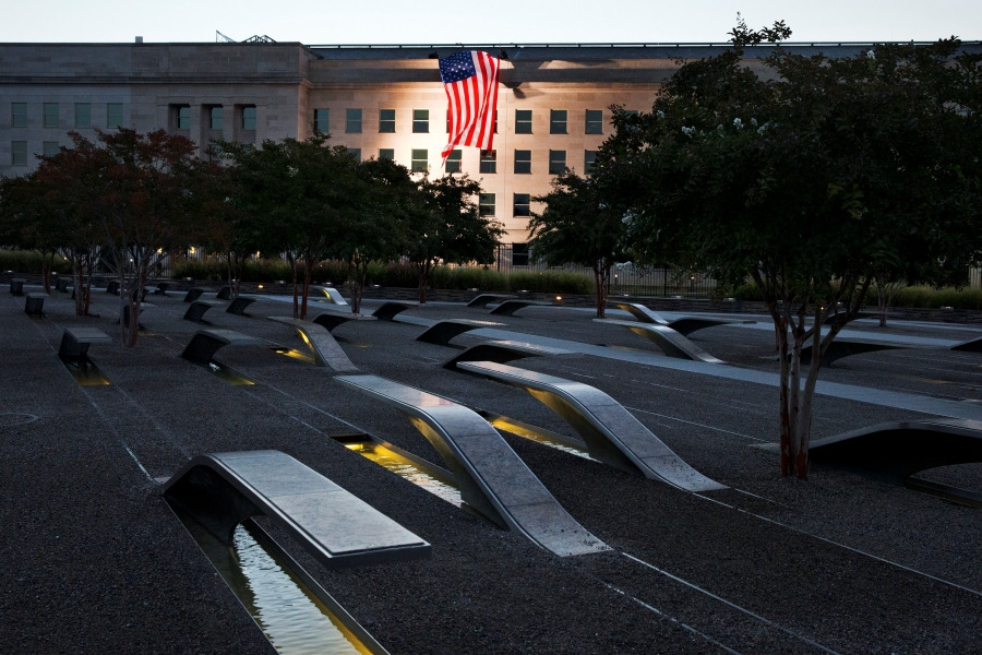 In this Friday Sept. 11, 2015 file photo, a U.S. flag is draped on the side of the Pentagon where the attack took place 14 years earlier, seen from the Pentagon Memorial.