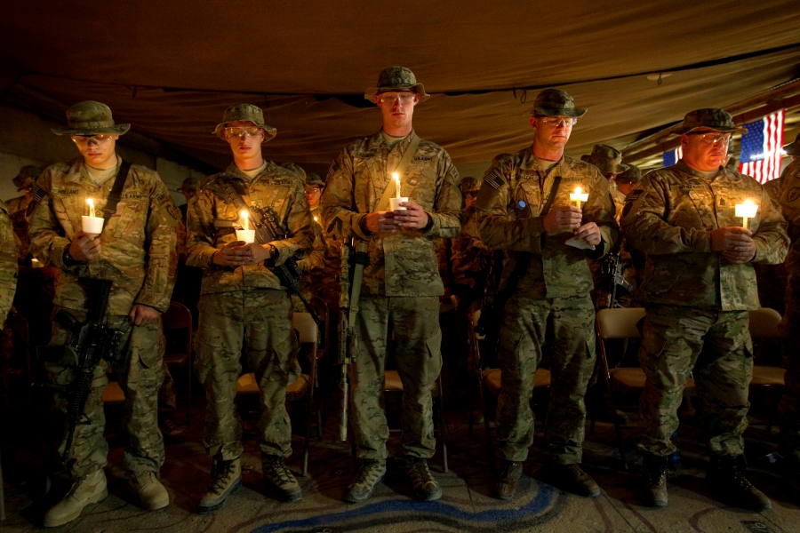 In this Sunday, Sept. 11, 2011 file photo, soldiers with the U.S. Army's 25th Infantry Division, 3rd Brigade Combat Team, 2nd Battalion 27th Infantry Regiment based in Schofield Barracks, Hawaii, hold a ceremony commemorating the tenth anniversary of the 9/11 attacks and soldiers the unit has lost since then in the wars in Iraq and Afghanistan at Forward Operating Base Bostick in Kunar province, Afghanistan.