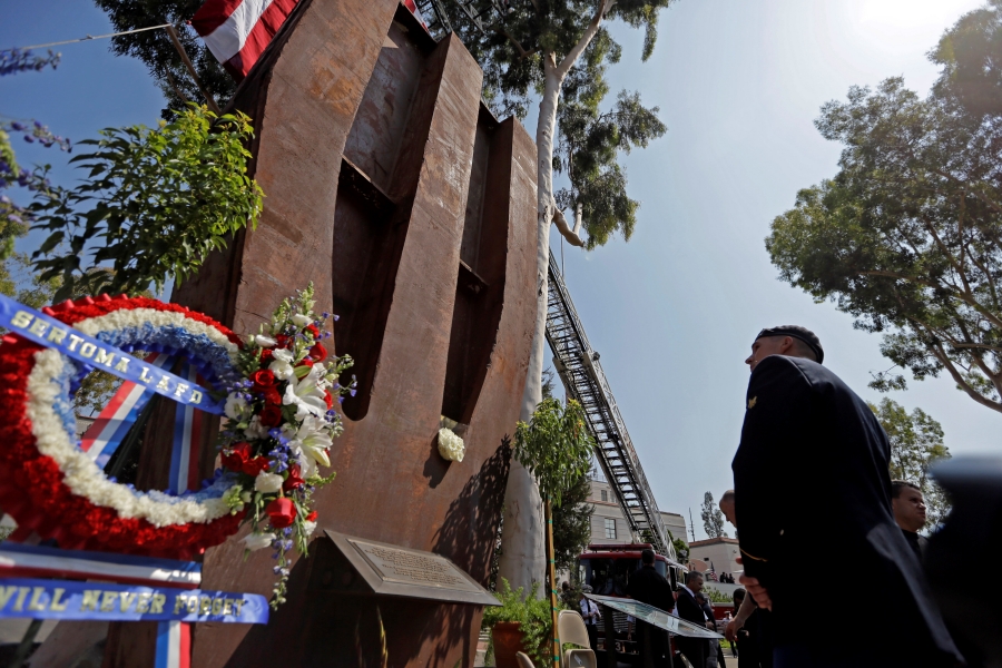 In this Wednesday, Sept. 11, 2013 file photo, a U.S. army soldier pauses at a column from the South Tower of the World Trade Center at the Los Angeles Fire Department's Sept. 11 remembrance ceremony in Los Angeles.