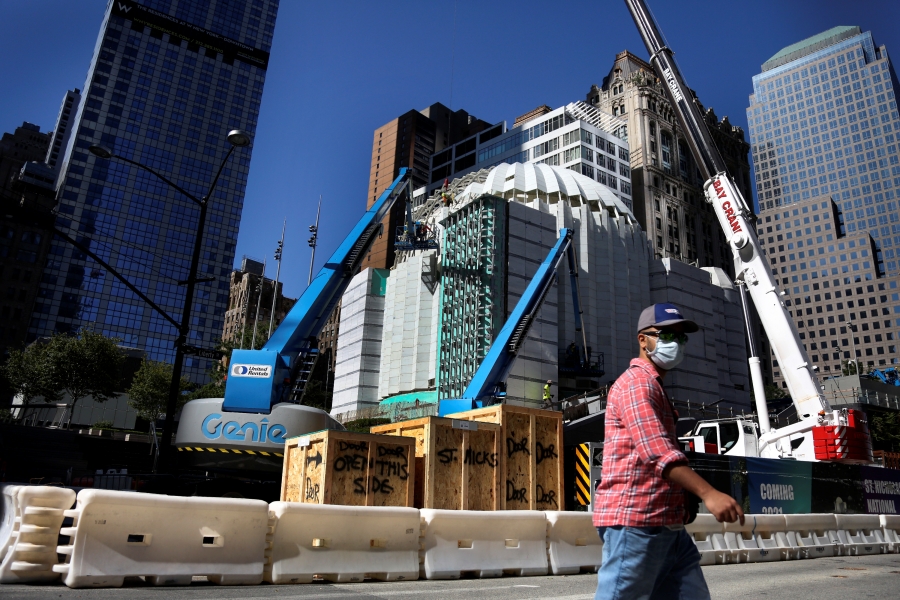 Cranes lift sections of marble over the dome of St. Nicholas Greek Orthodox Church and National Shrine on Thursday, Sept. 2, 2021, in New York. The shrine will have a ceremonial lighting on the eve of the 20th anniversary of the Sept. 11, 2001 attacks, while the interior is slated for completion next year.