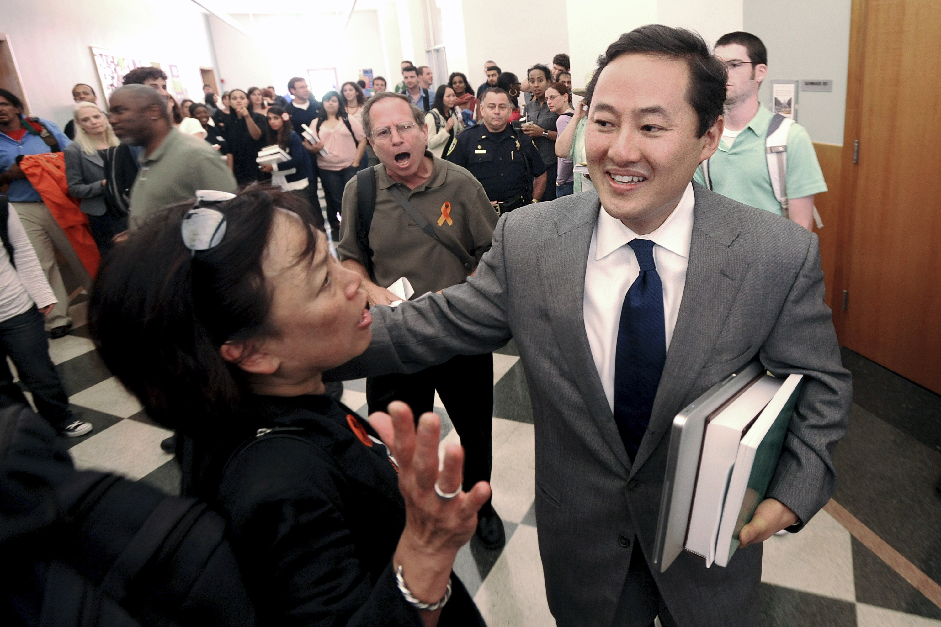 John Yoo, a constitutional law professor at the University of California, Berkeley, as he makes his way to a classroom in Berkeley, Calif. About 75 demonstrators called for the university to fire Yoo, a former Bush administration attorney, who wrote legal memos used to support harsh interrogation techniques that critics say constituted torture.