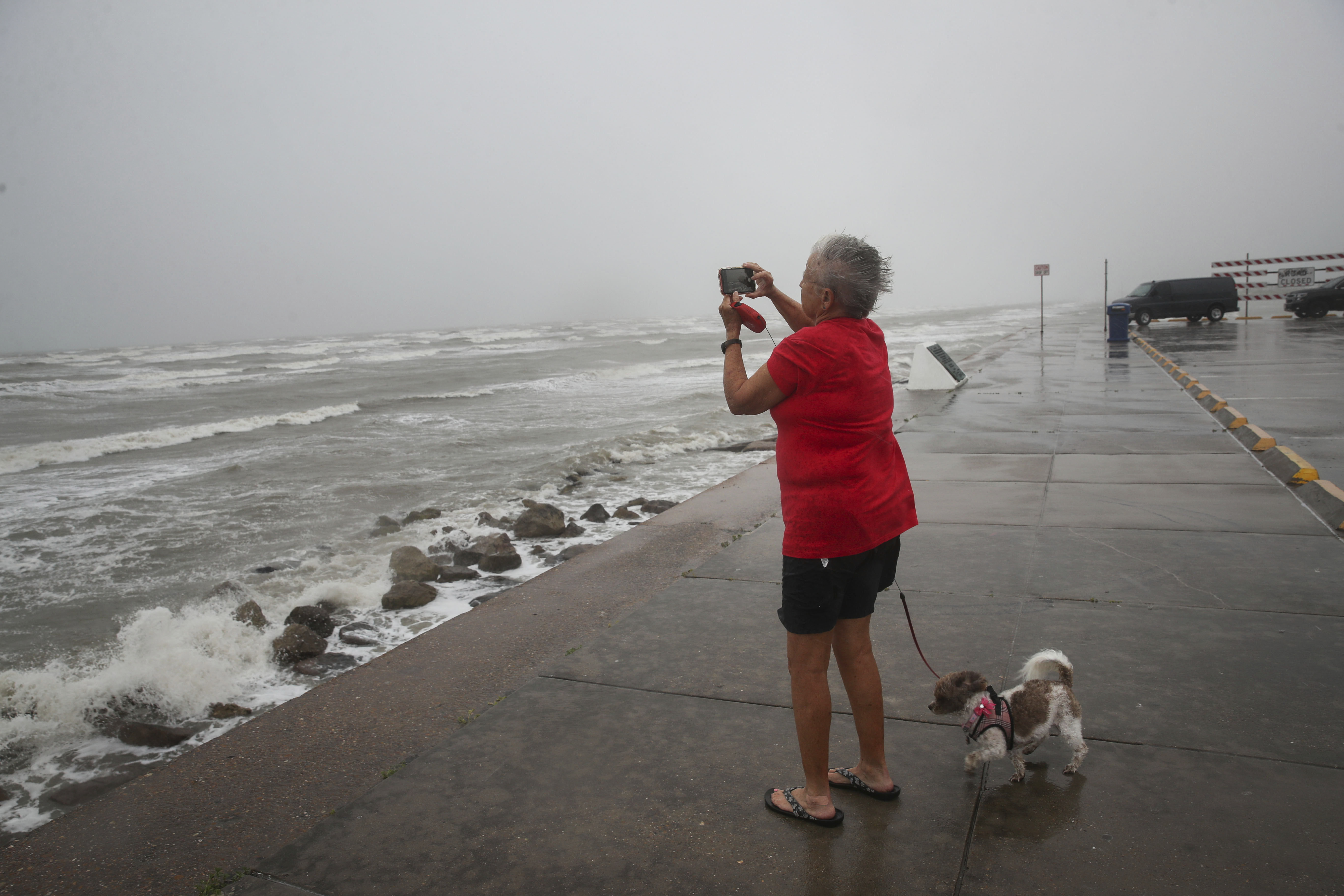 Cheri Daigle, a retired teacher, takes a photo as Tropical Storm Nicholas approaches the Texas coast