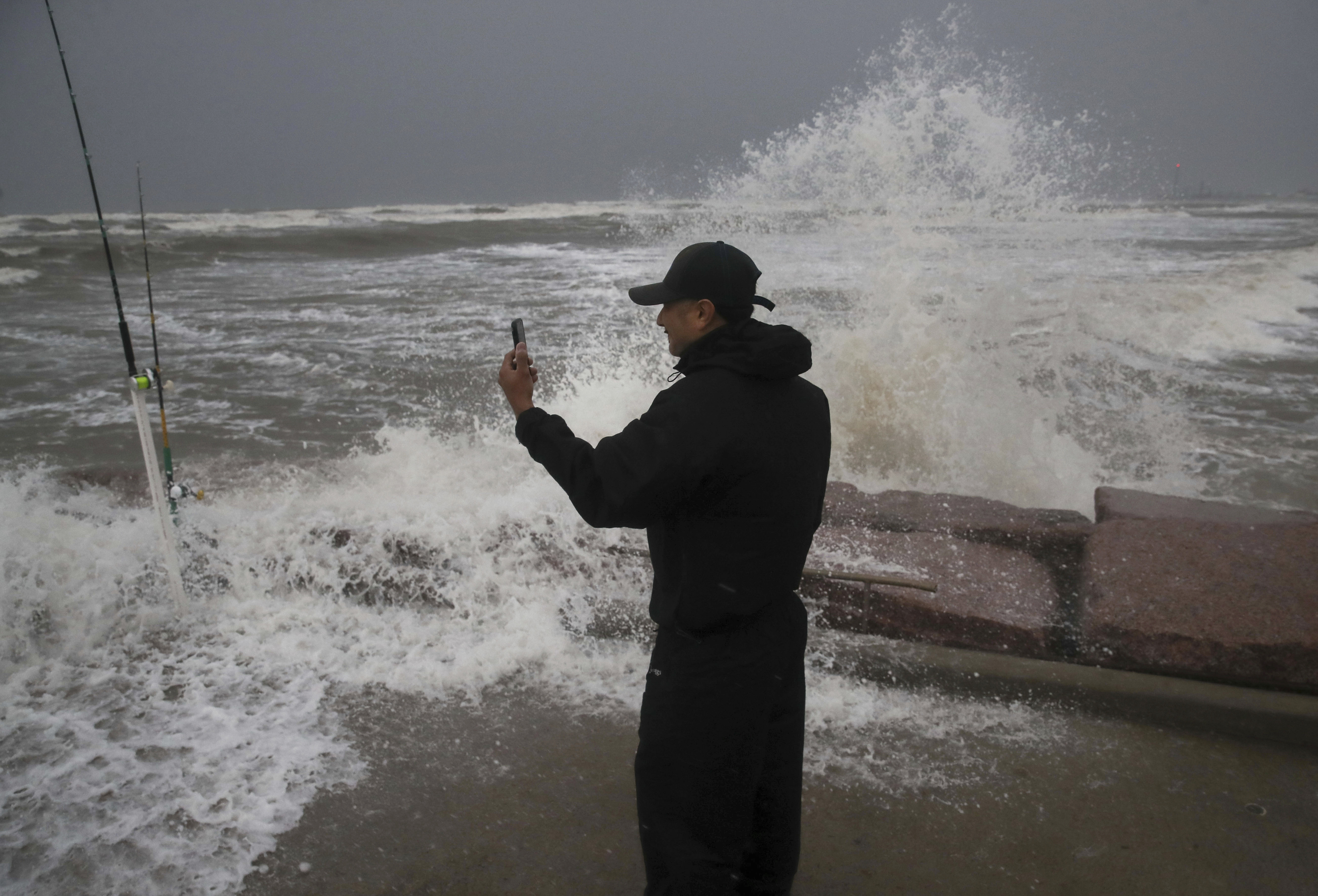 Frank Rivera streams a Facebook live as he fishes with a friend, while Tropical Storm Nicholas heads towards the Texas