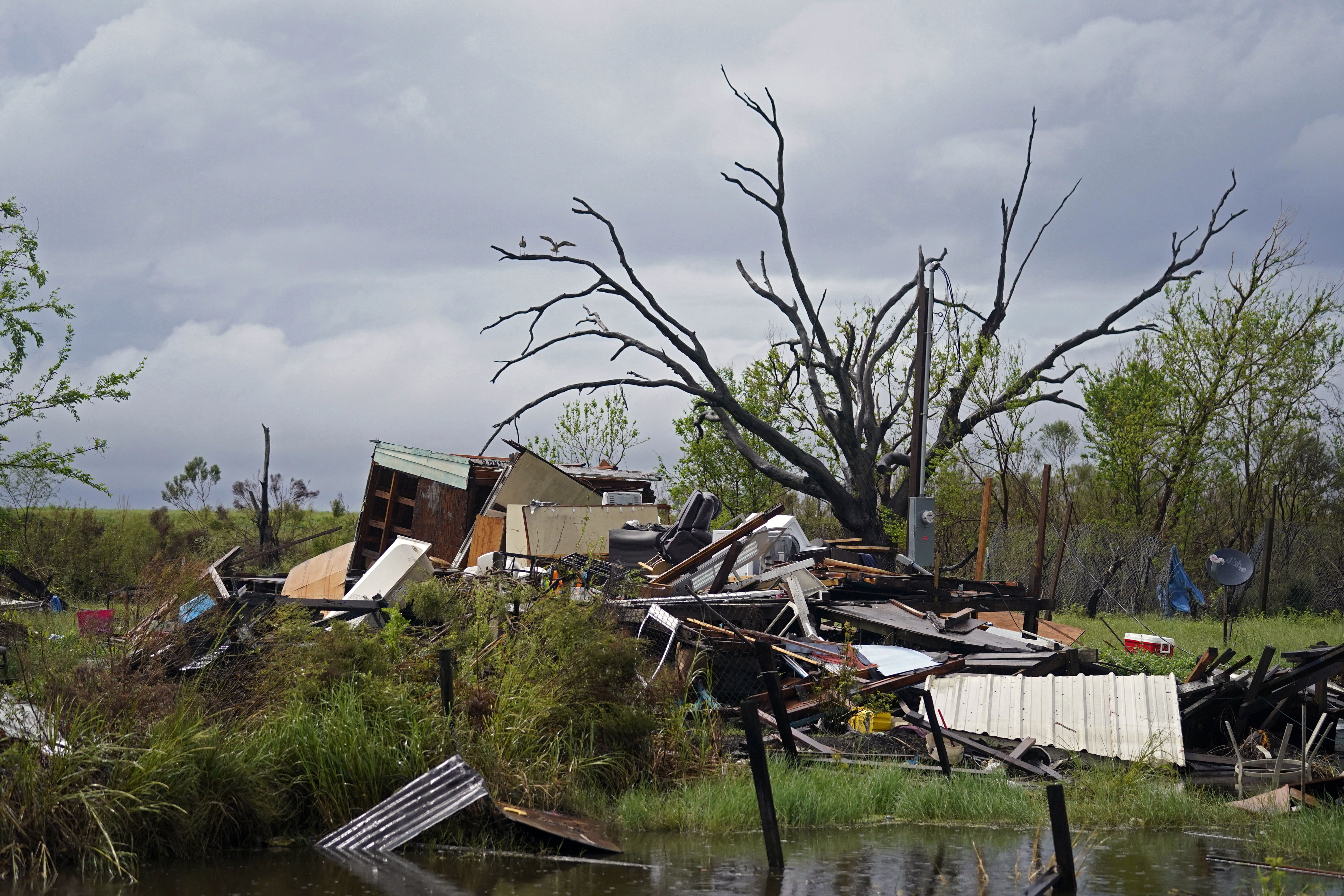 Storm clouds from approaching Tropical Storm Nicholas are seen behind homes destroyed by Hurricane Ida
