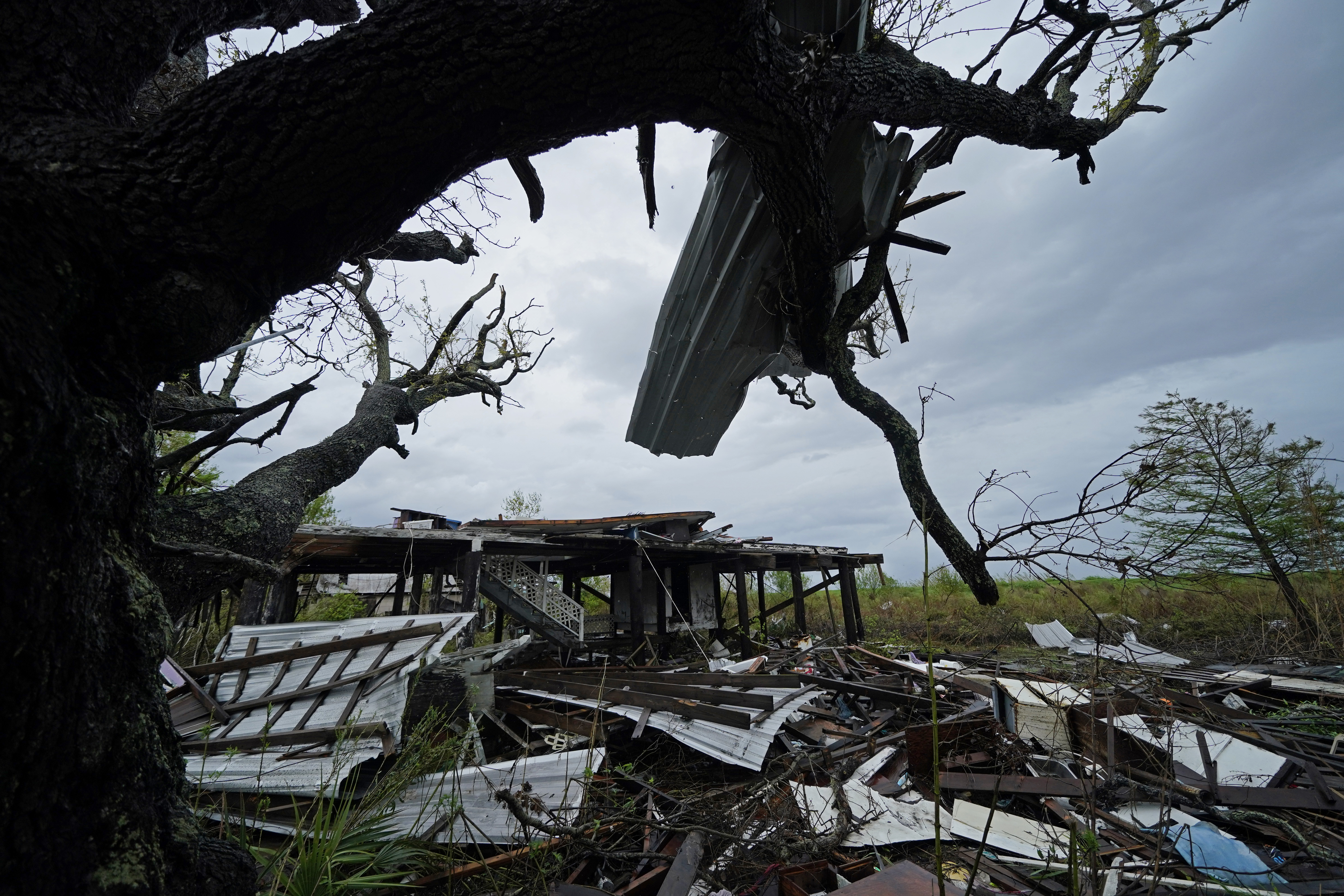 Storm clouds from Tropical Storm Nicholas are seen behind homes of the vanishing Native American community of Isle de Jean Charles