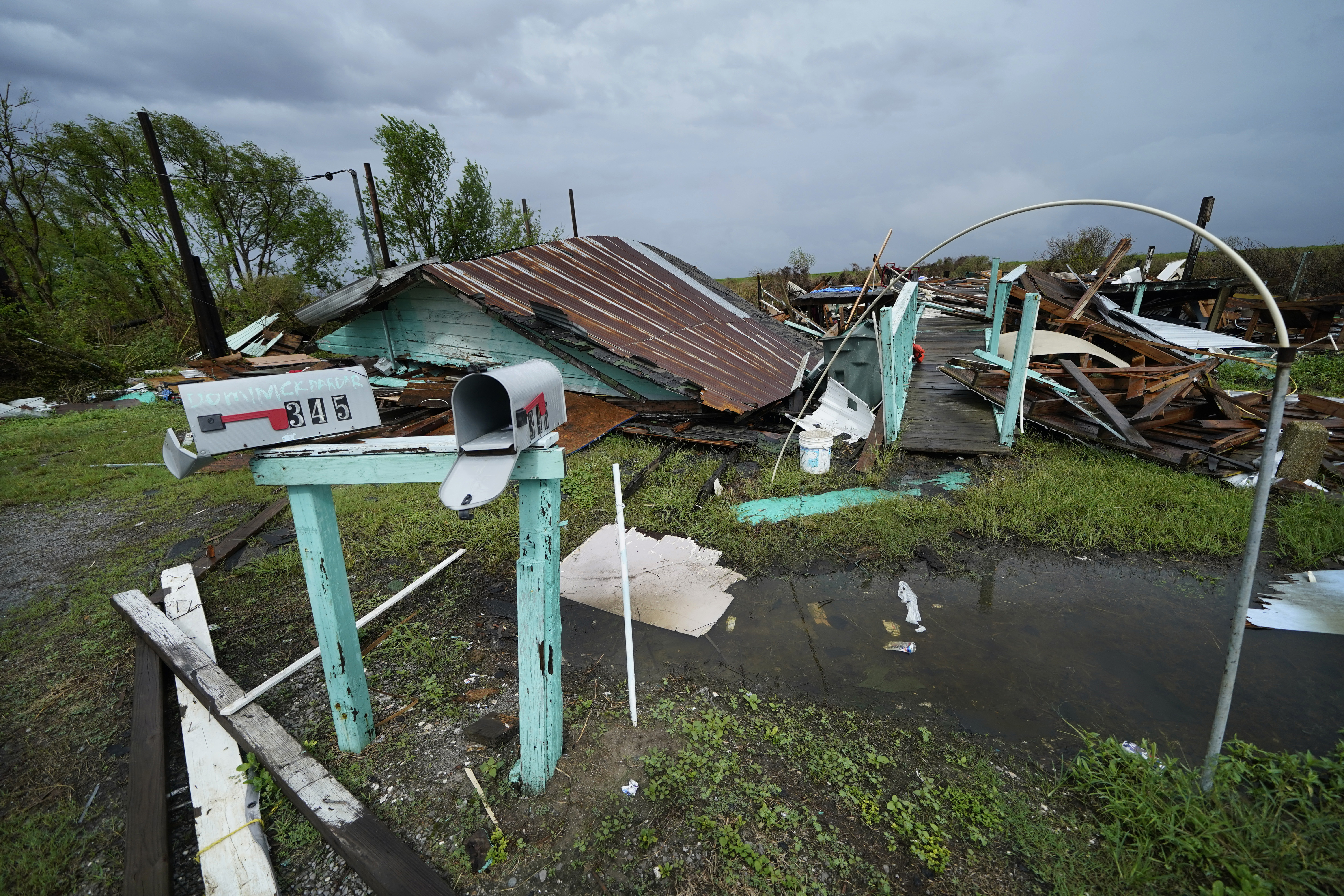Storm clouds from Tropical Storm Nicholas are seen behind homes of the vanishing Native American community of Isle de Jean Charles