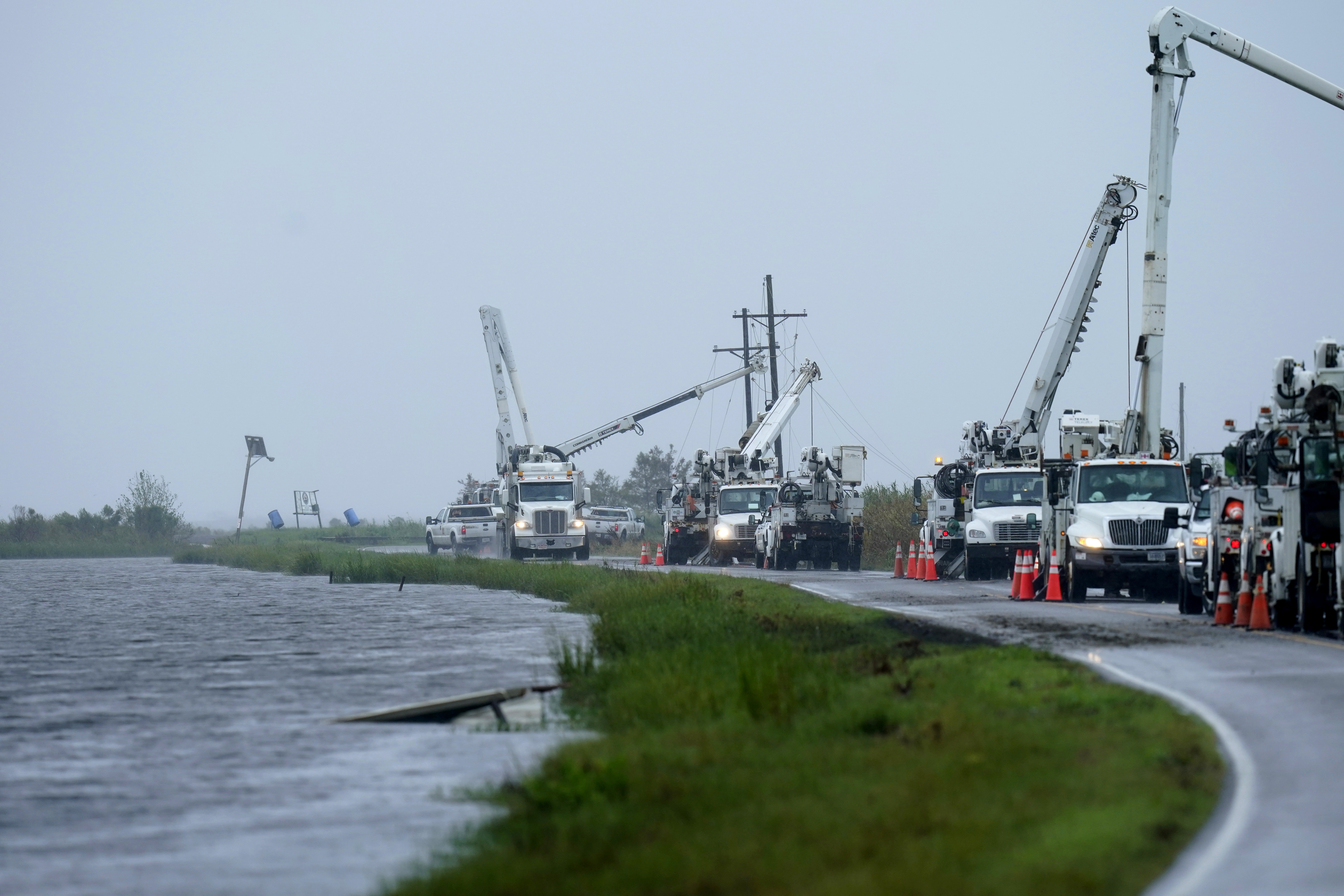 Utility crews replace power poles destroyed by Hurricane Ida as Tropical Storm Nicholas approaches in Pointe-aux-Chenes