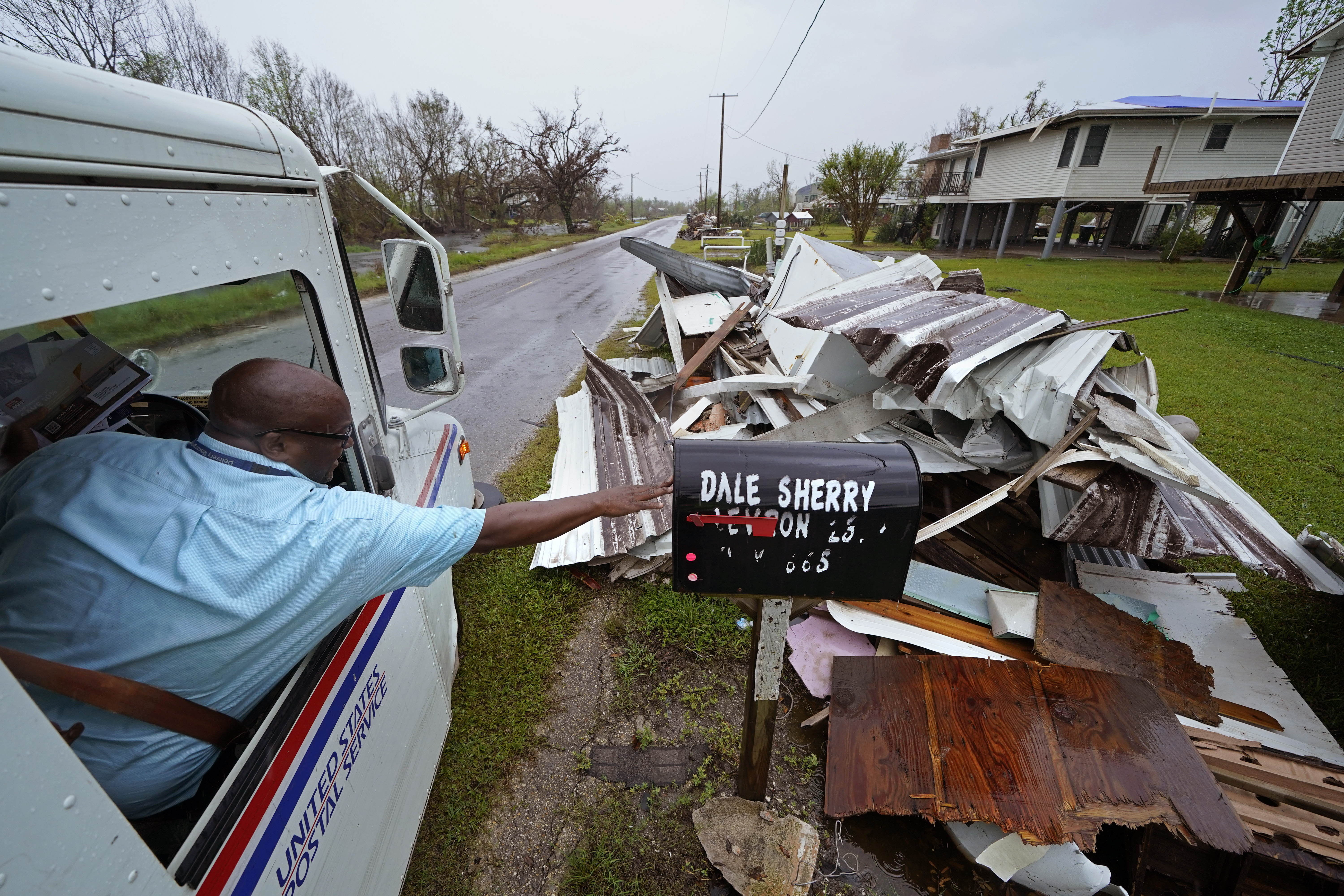 Derrick Campbell, postmaster for Montegut, La., delivers mail amidst destruction from Hurricane Ida, in Pointe-aux-Chenes